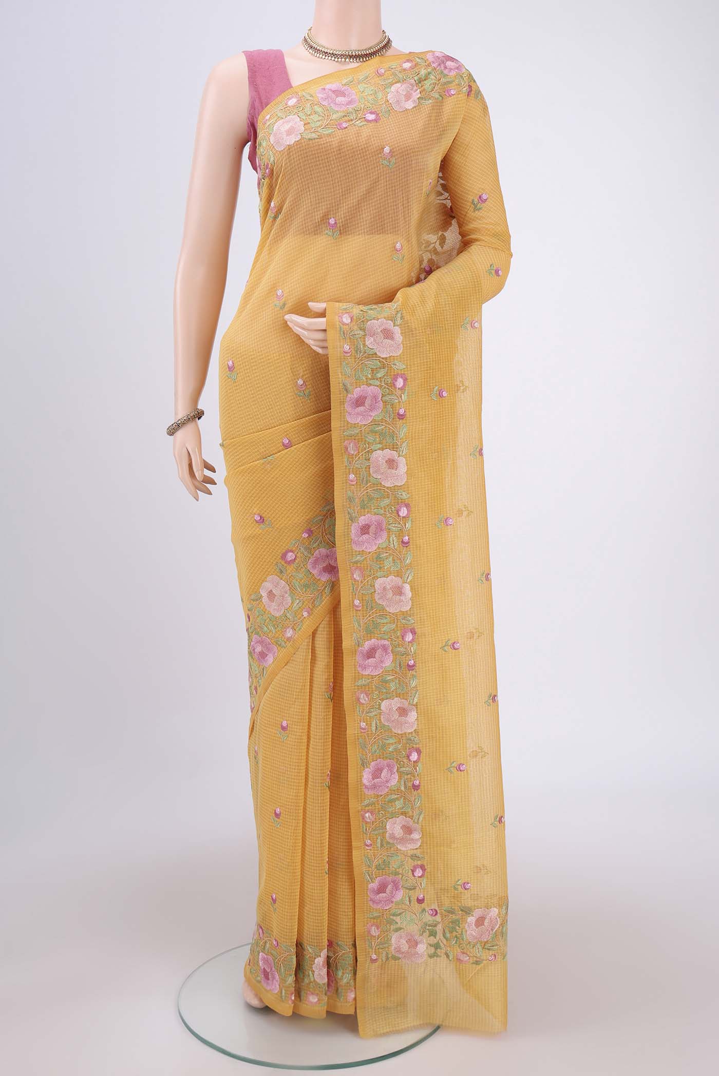 Yellow Kota Cotton Saree with Embroidery on the body and Thread Border.  displayed on a mannequin