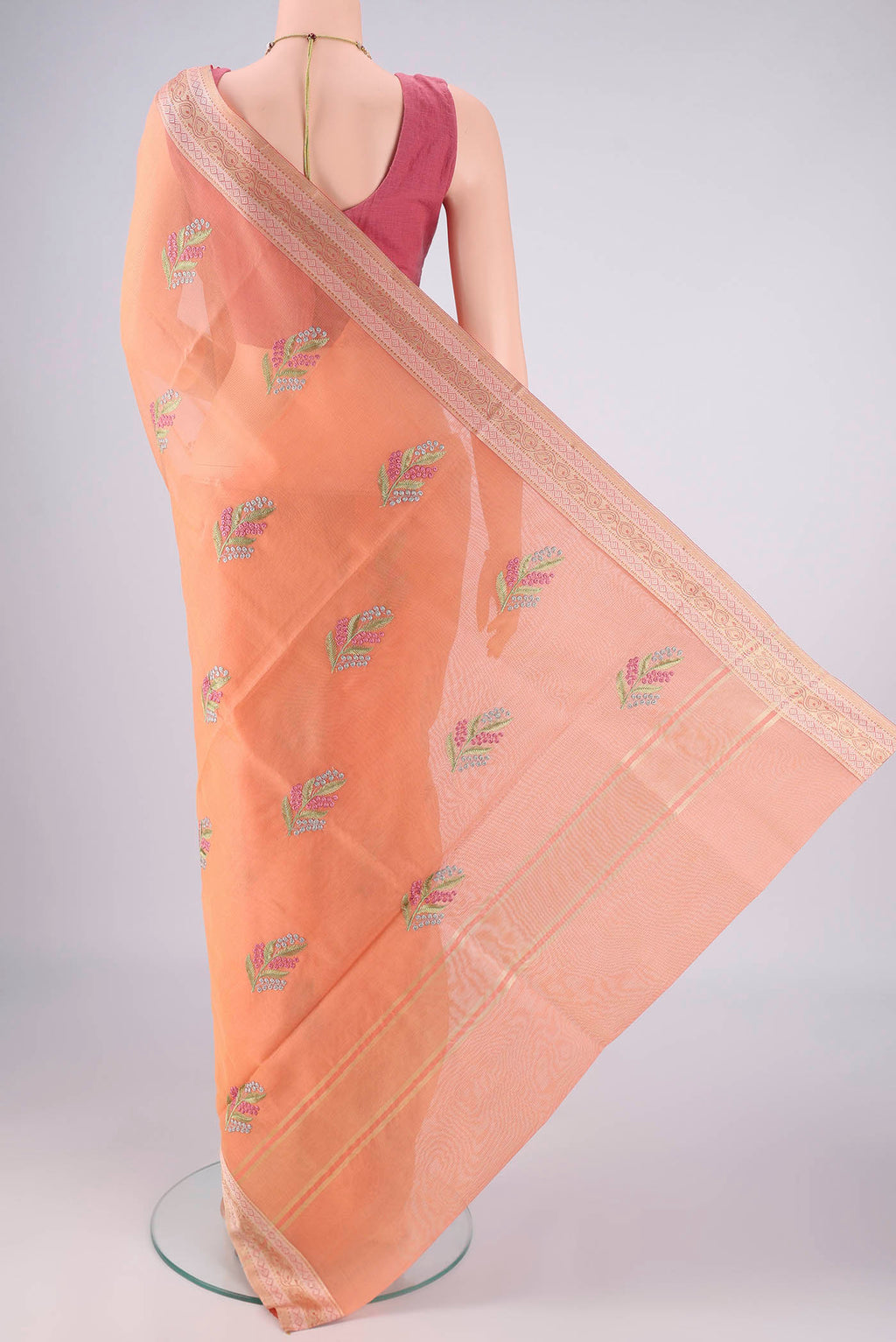 Flat view of Peach Blended Kota Cotton Saree with Embroidery on the body and Zari And Thread Border. 