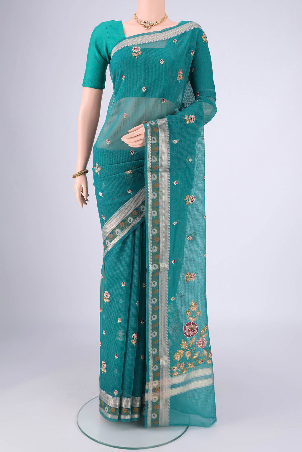 Sea Green Blended Kota Cotton Saree with Embroidery on the body and Zari Border.  displayed on a mannequin