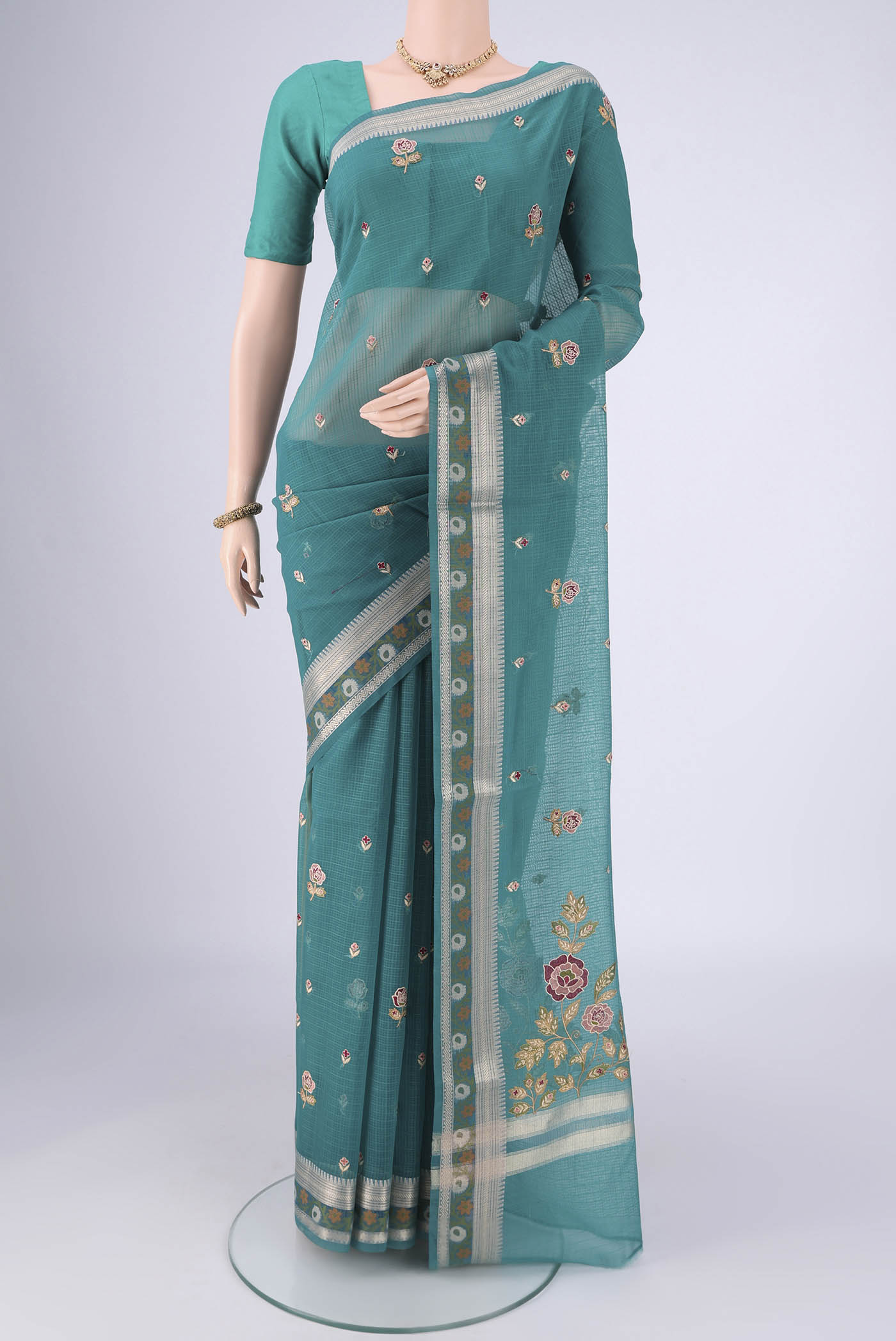 Sea Green Blended Kota Cotton Saree with Embroidery on the body and Zari Border.  displayed on a mannequin