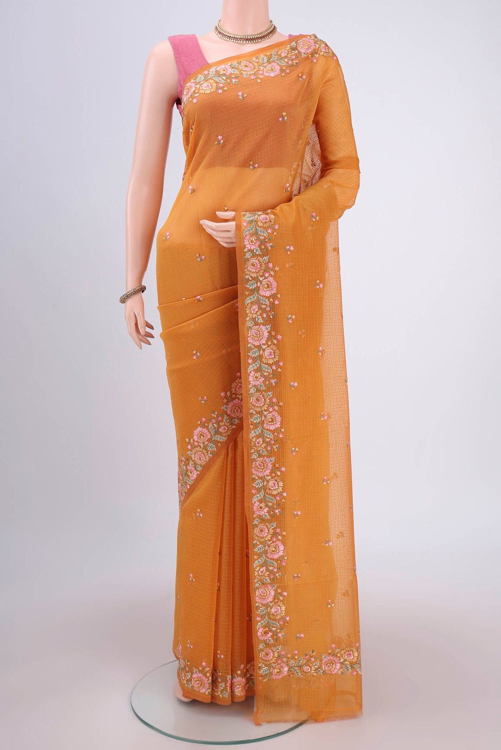 Brick Orange Kota Cotton Saree with Embroidery on the body and Thread Border.  displayed on a mannequin