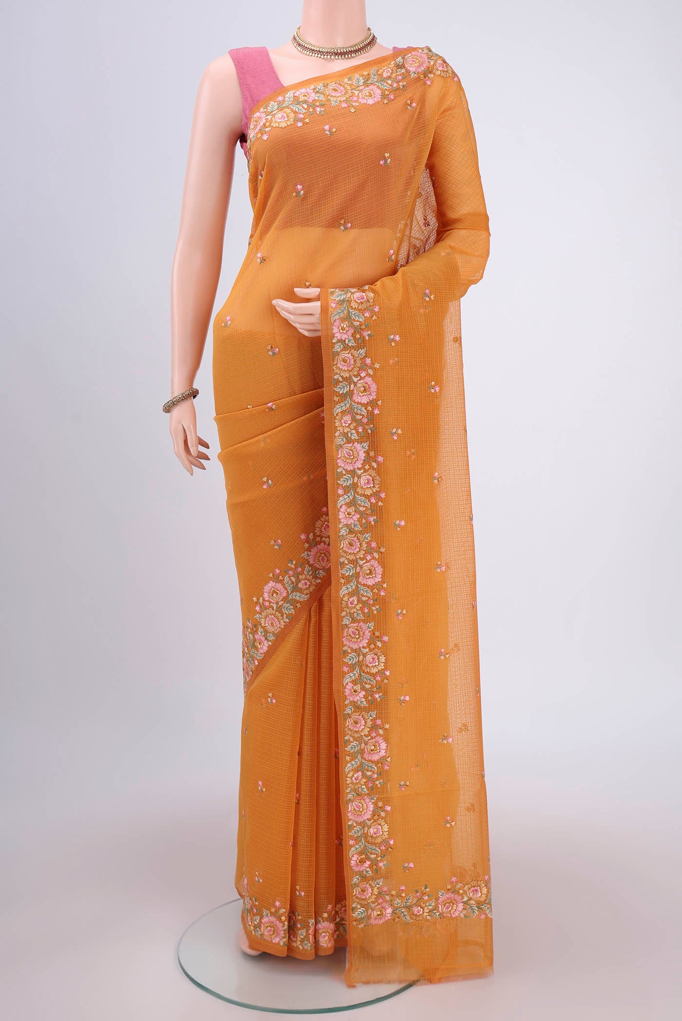 Brick Orange Kota Cotton Saree with Embroidery on the body and Thread Border.  displayed on a mannequin