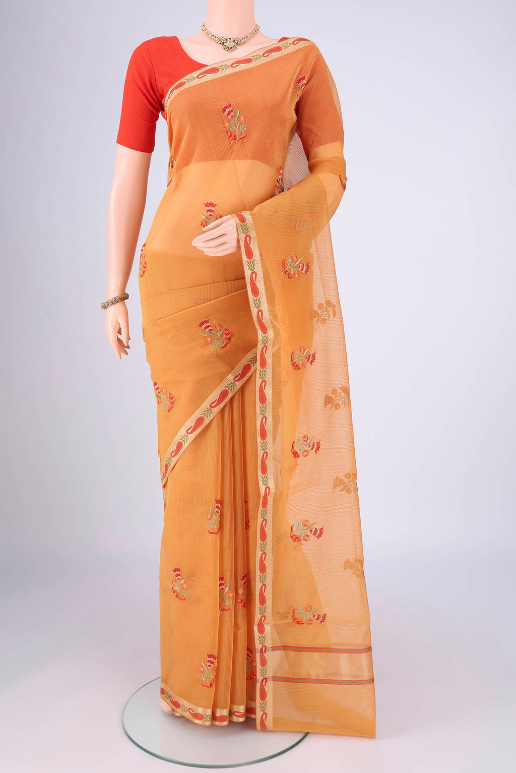 Sandal Blended Kota Cotton Saree with Embroidery on the body and Zari Border.  displayed on a mannequin