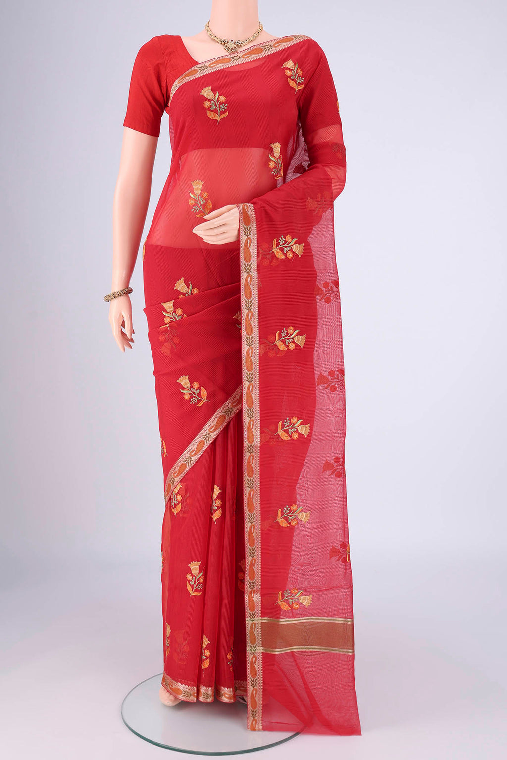 Red Blended Kota Cotton Saree with Embroidery on the body and Zari And Thread Border.  displayed on a mannequin
