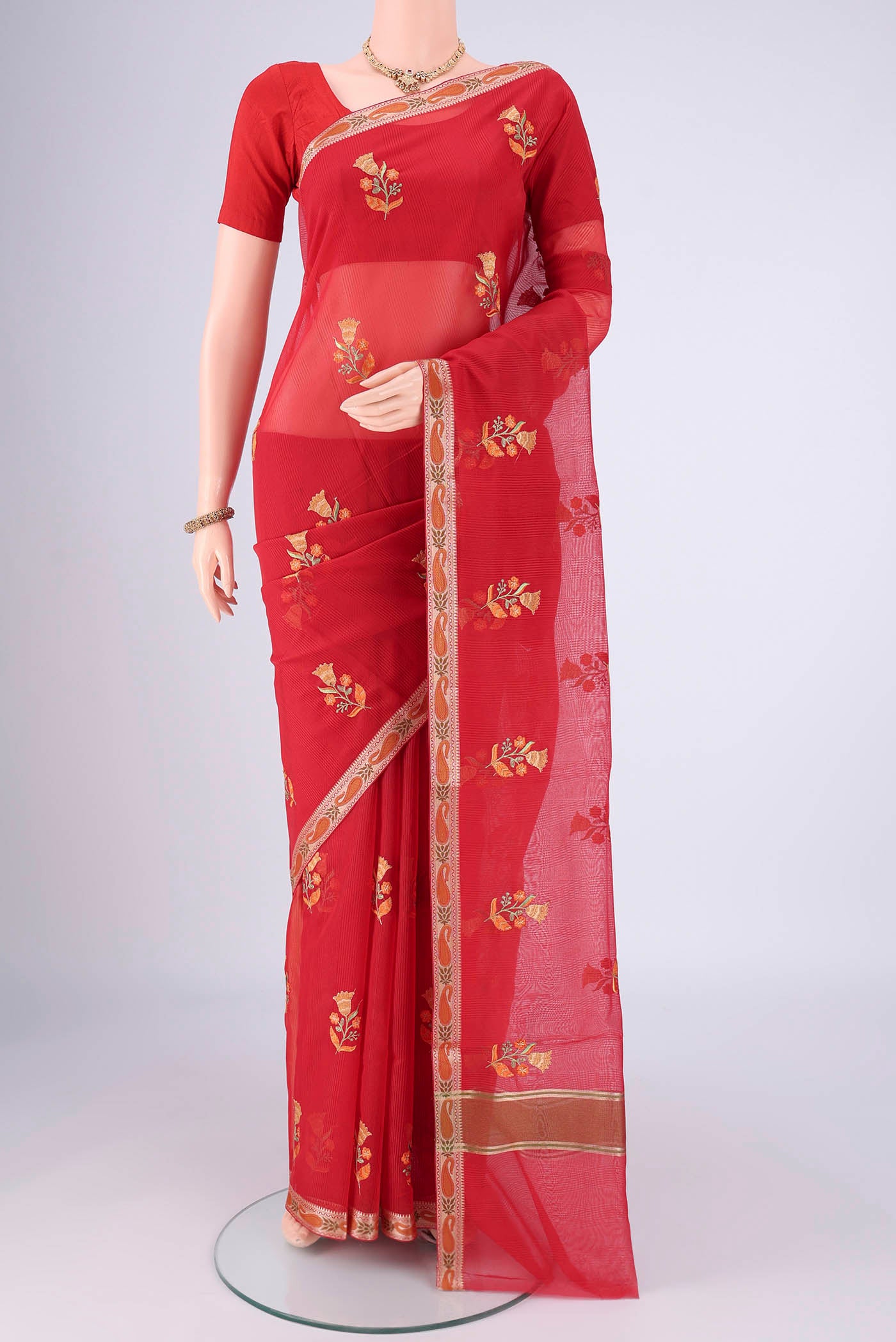 Red Blended Kota Cotton Saree with Embroidery on the body and Zari And Thread Border.  displayed on a mannequin