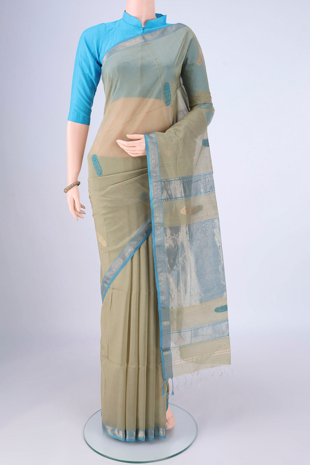 Sage Green Maheshwari Silk Cotton Saree with Thread Butta on the body and Zari Border.  displayed on a mannequin