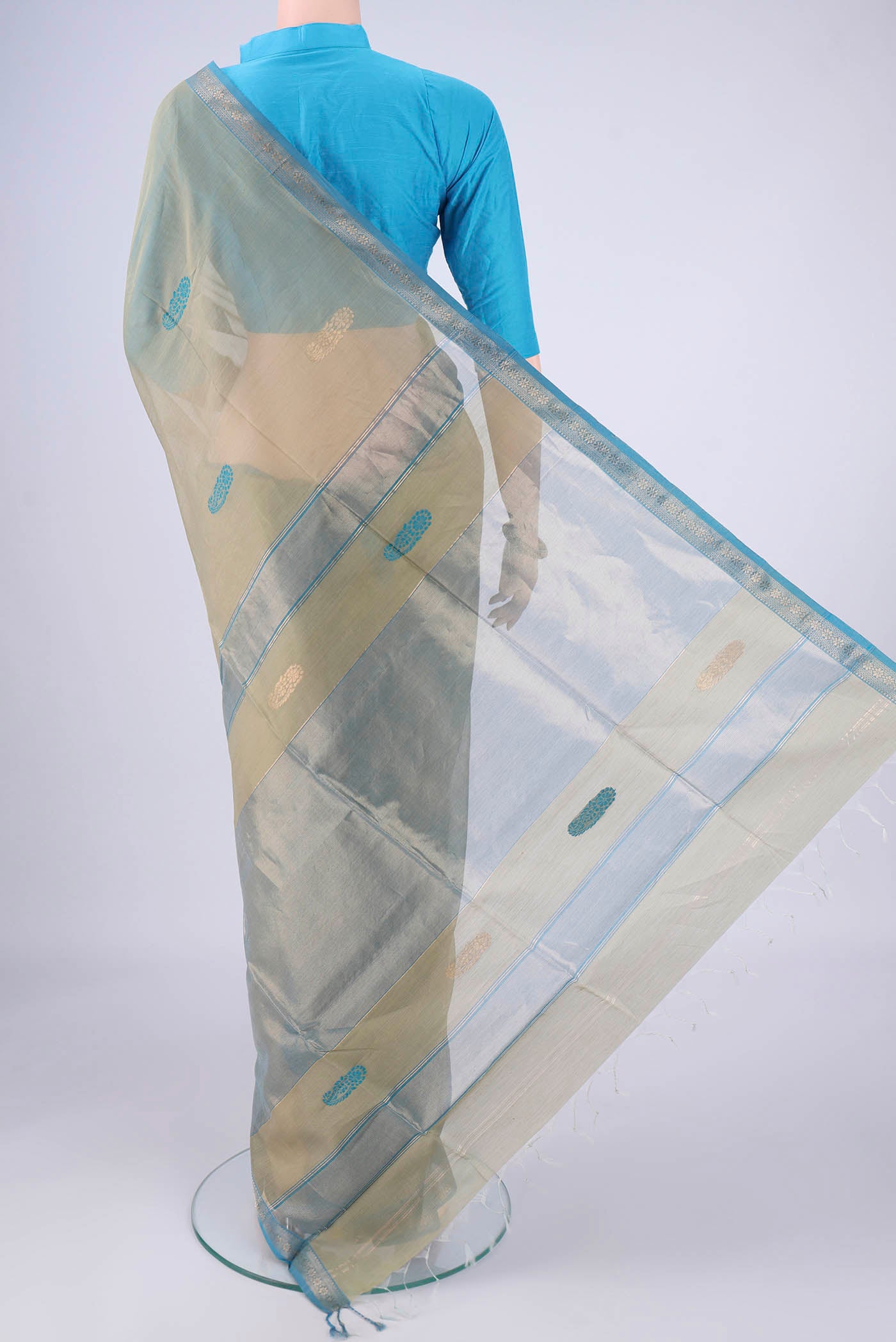 Flat view of Sage Green Maheshwari Silk Cotton Saree with Thread Butta on the body and Zari Border. 