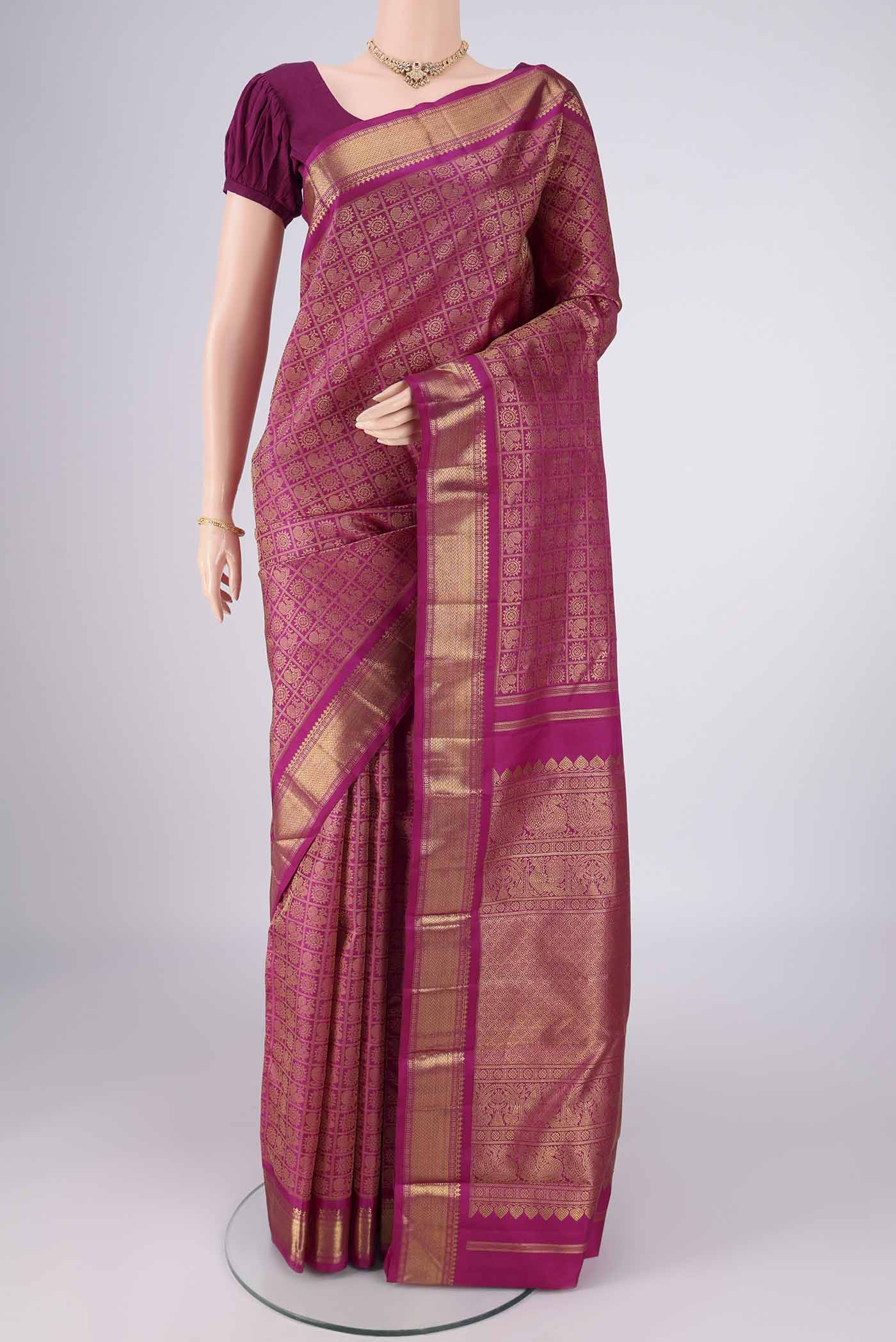 Pure Silk Pure Zari Light Magenta Kanjivaram Saree with Zari Brocade on the body and Zari Border.  displayed on a mannequin