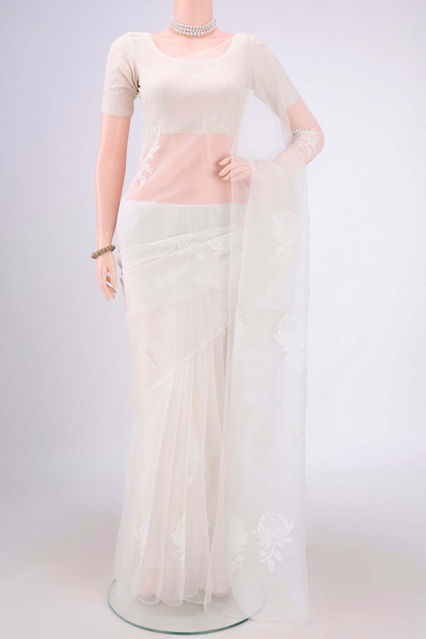 White Organza Silk Saree with Embroidery on the body and Thin Zari Line.  displayed on a mannequin