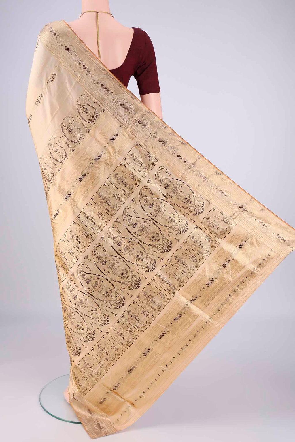 Flat view of Cream Baluchari Silk Saree with Zari And Thread Butta on the body and Zari And Thread Border. 