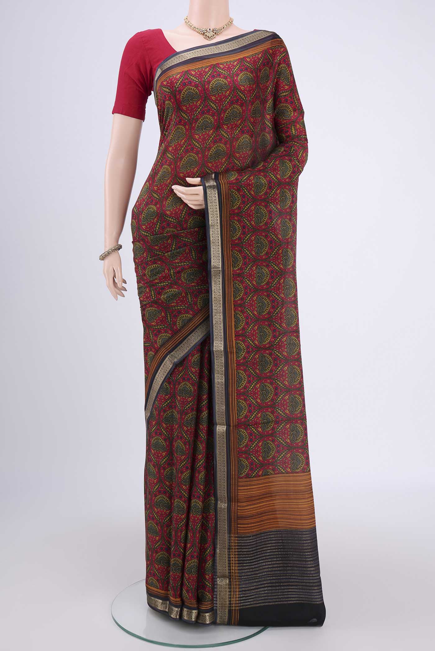 Red Mysore Crepe Saree with Floral Print on the body and Zari Border.  displayed on a mannequin