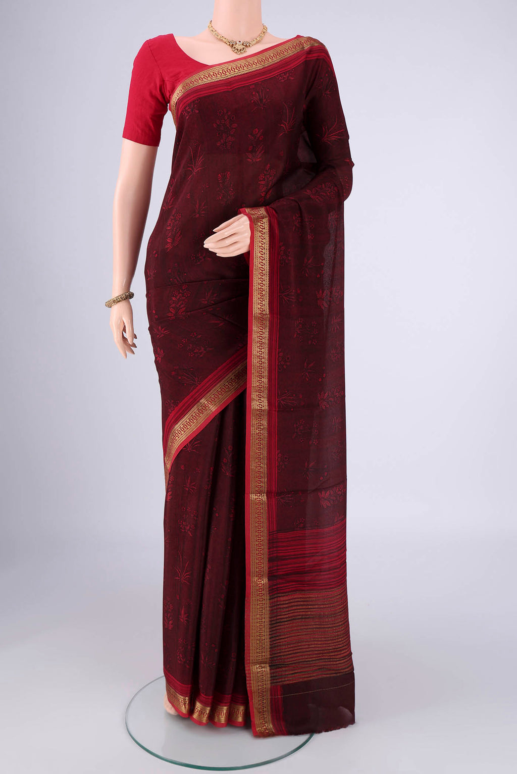 Maroon Mysore Crepe Saree with Printed design on the body and Zari Border.  displayed on a mannequin