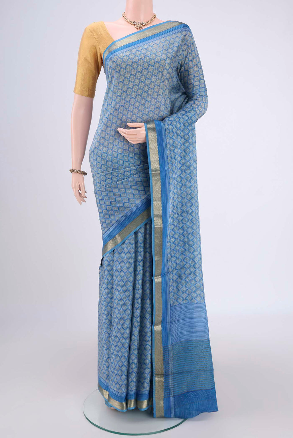 Blue Mysore Crepe Saree with Floral Print on the body and Zari Border.  displayed on a mannequin