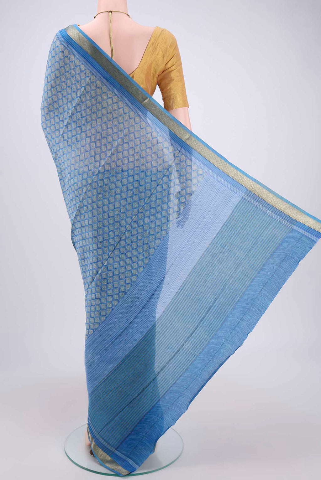 Flat view of Blue Mysore Crepe Saree with Floral Print on the body and Zari Border. 