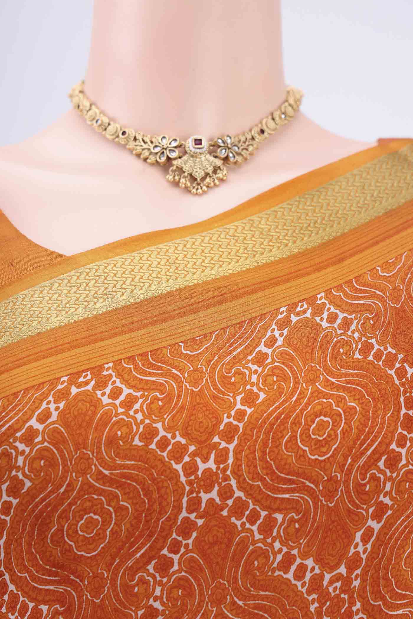 Border image of Orange Mysore Crepe Saree with Floral Print on the body and Zari Border. 
