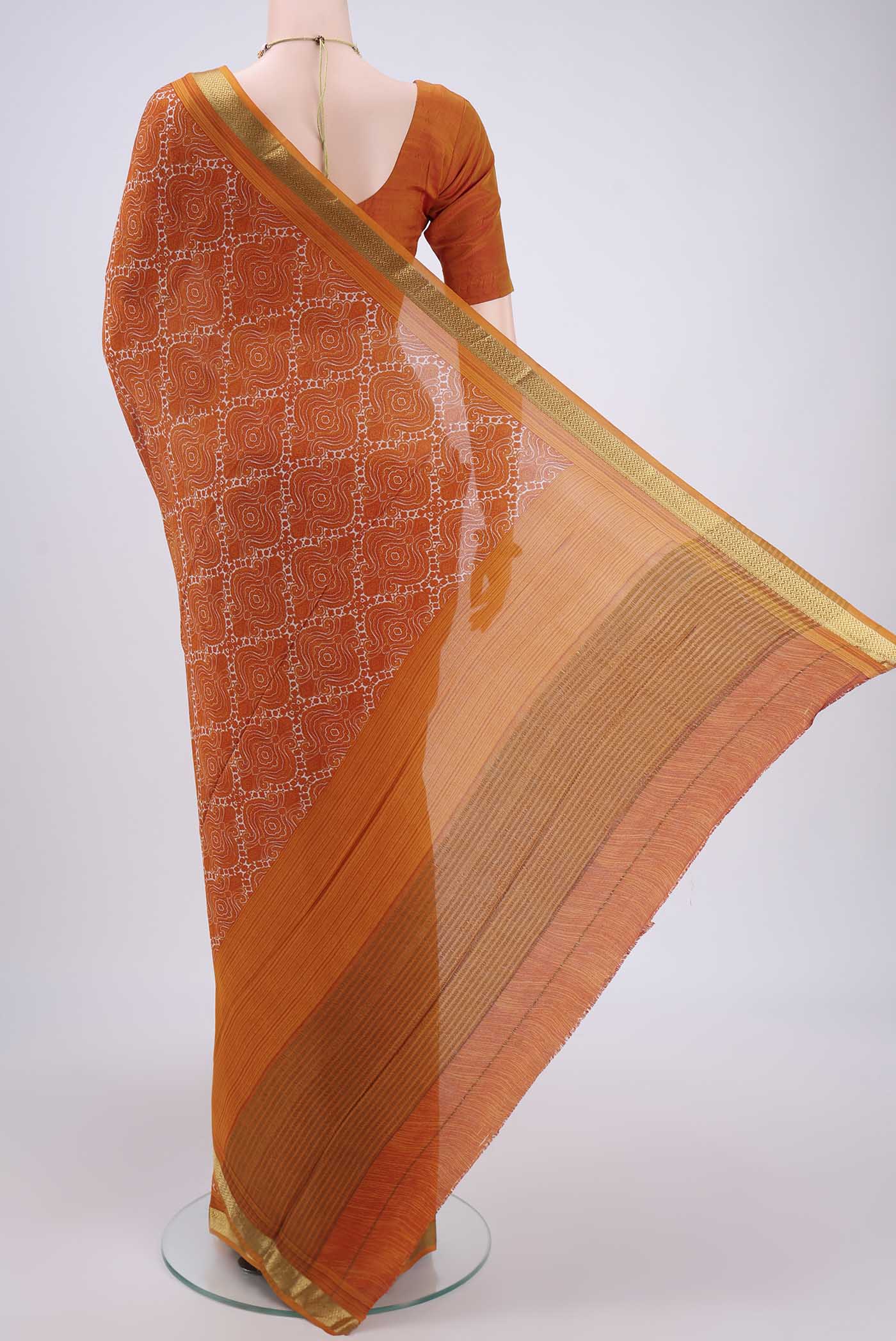 Flat view of Orange Mysore Crepe Saree with Floral Print on the body and Zari Border. 