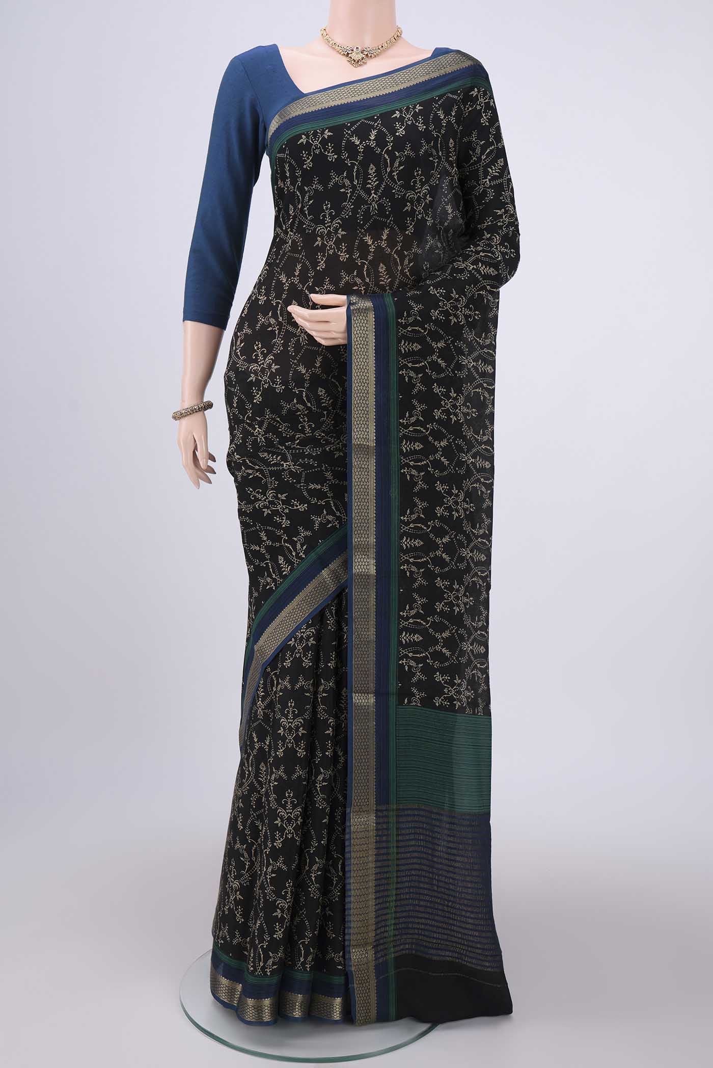 Black Mysore Crepe Saree with Floral Print on the body and Zari Border.  displayed on a mannequin