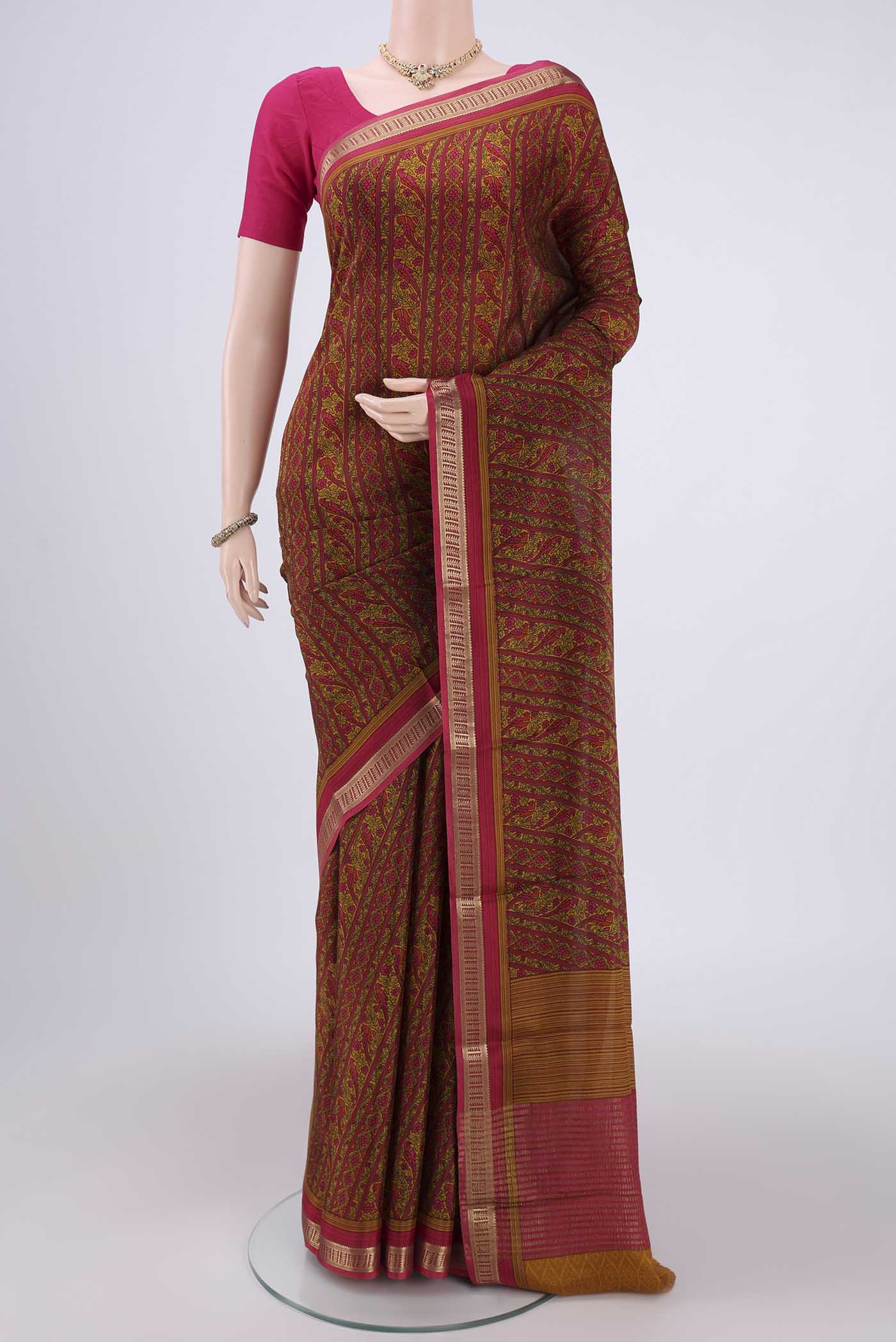 Pink Mysore Crepe Saree with Floral Print on the body and Zari Border.  displayed on a mannequin