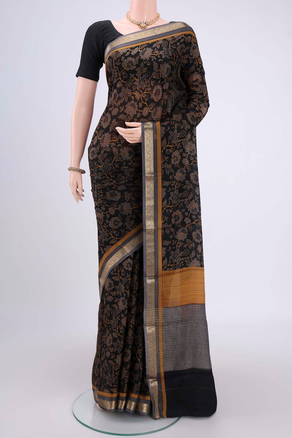 Black Mysore Crepe Saree with Floral Print on the body and Zari Border.  displayed on a mannequin