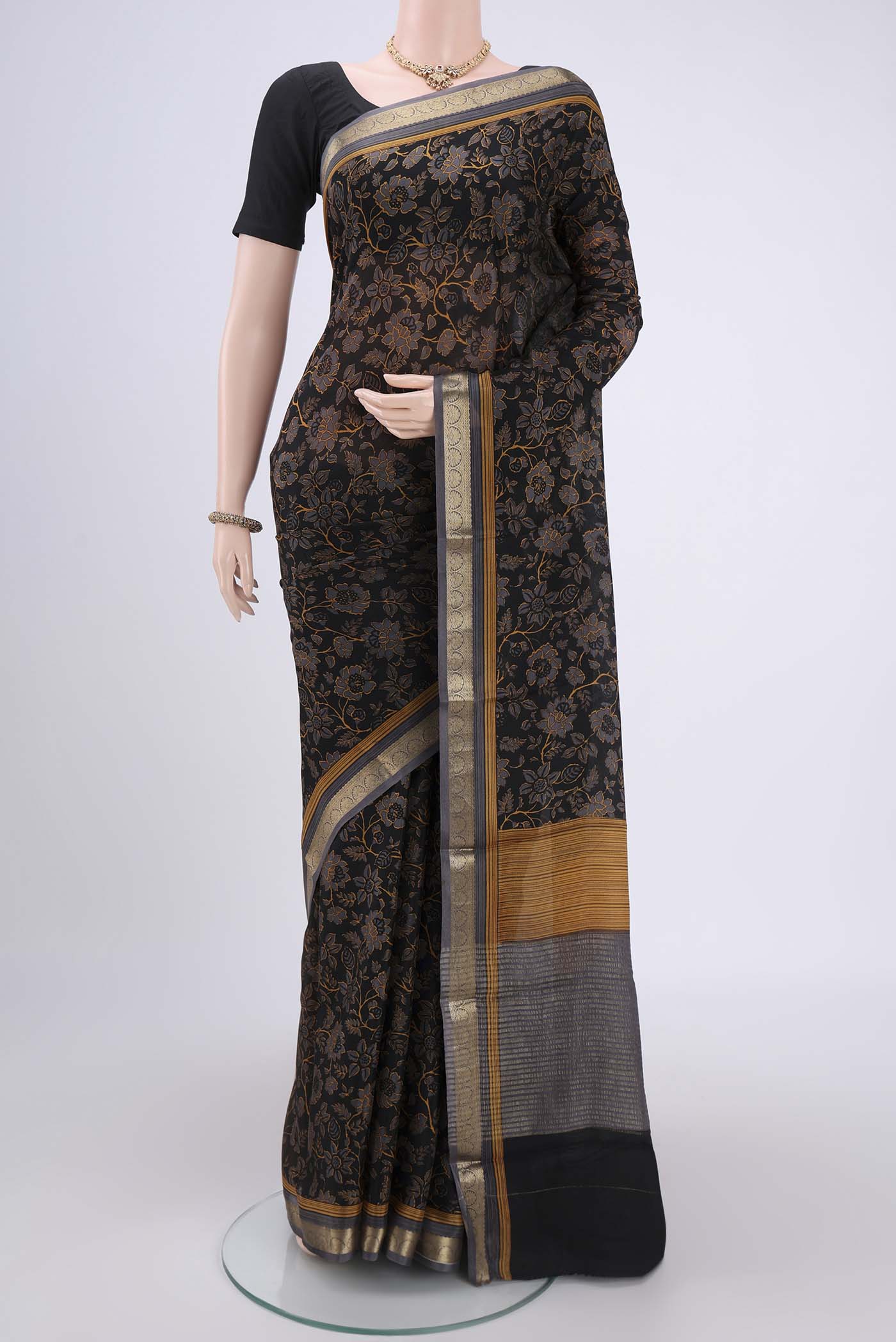 Black Mysore Crepe Saree with Floral Print on the body and Zari Border.  displayed on a mannequin