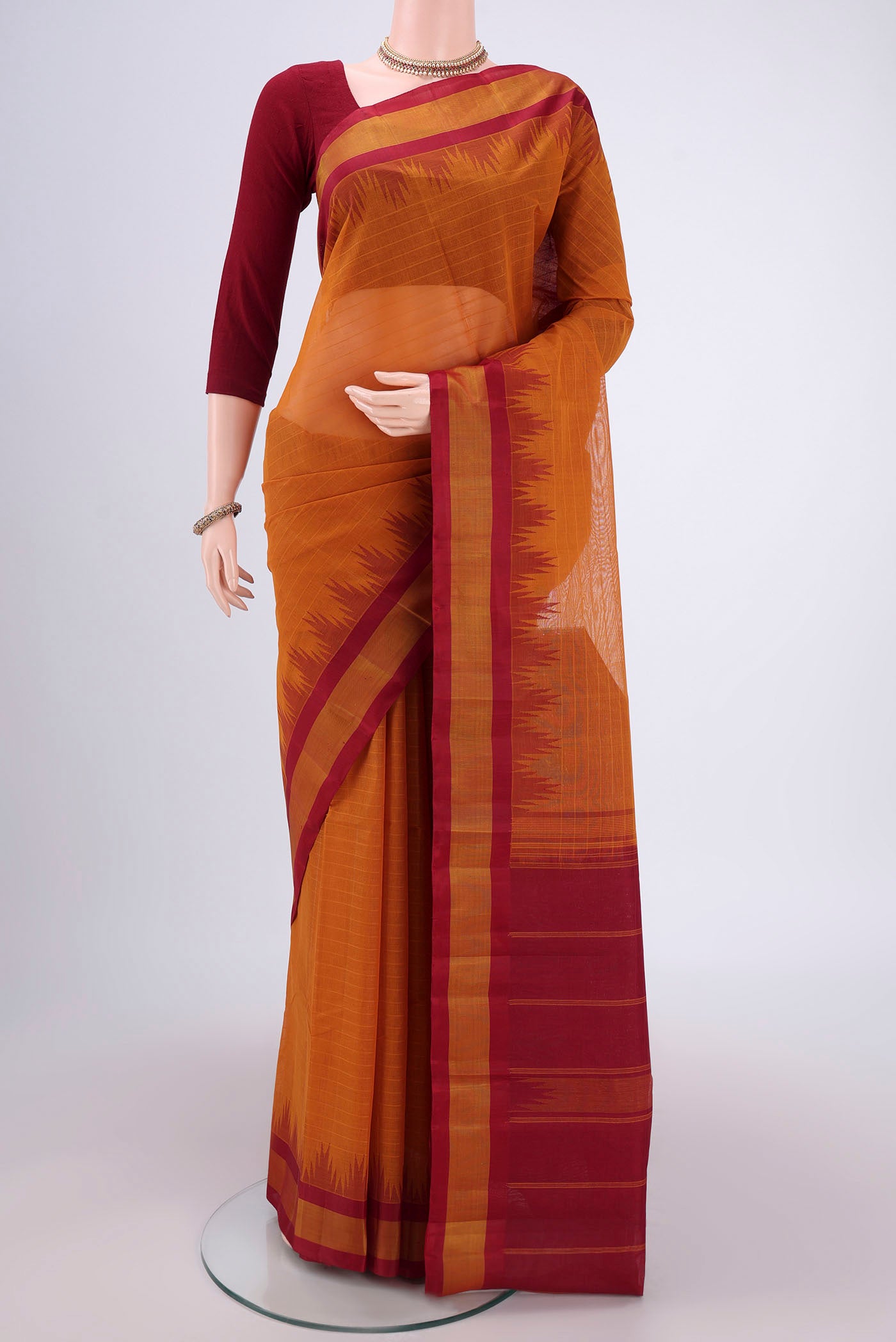 Mustard Kanchi Cotton Saree with Plain Body and Silk Border.  displayed on a mannequin