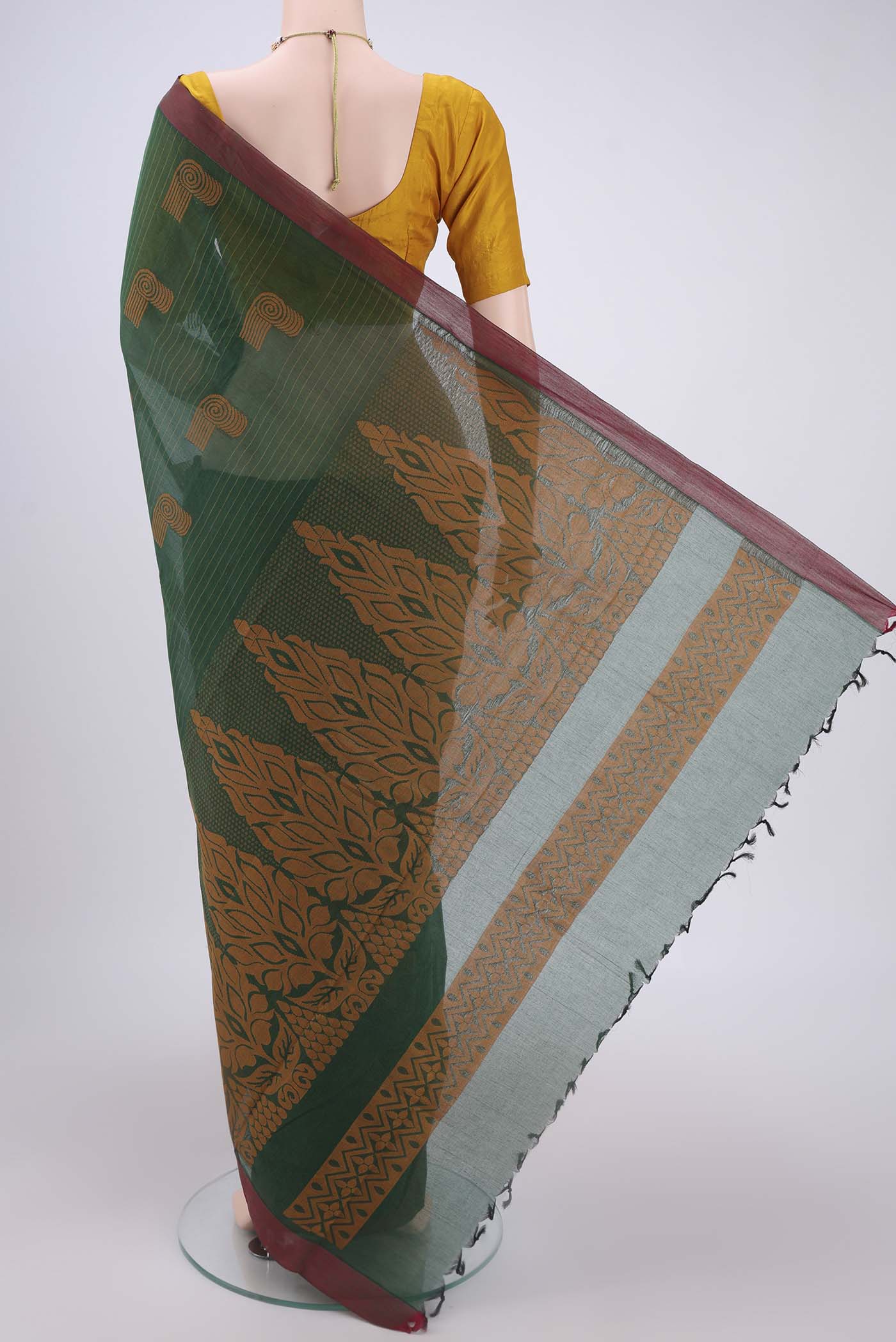 Flat view of Bottle Green Kanchi Cotton Saree with Thread Butta on the body and Plain Border. 