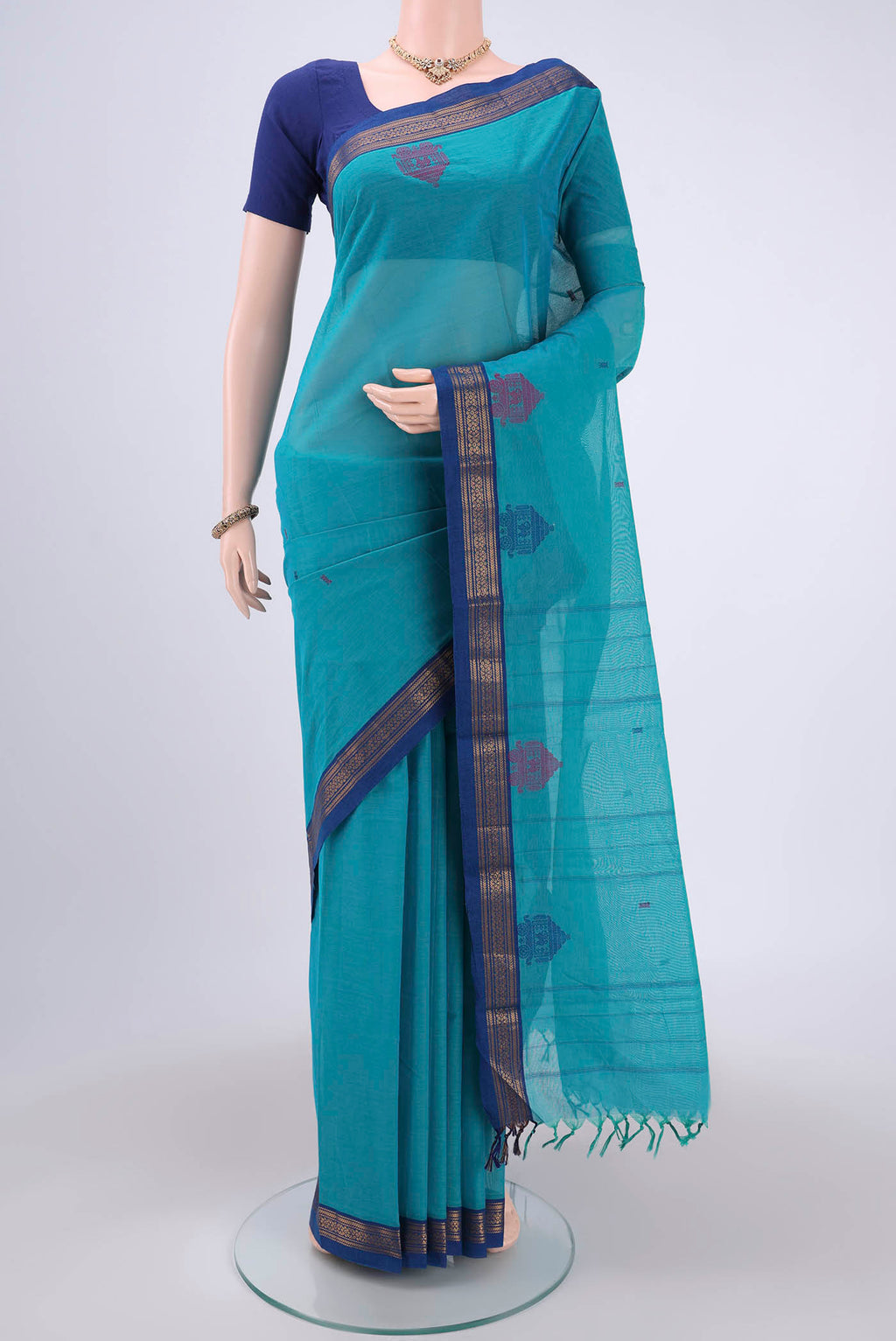 Turquoise Kanchi Cotton Saree with Thread Butta on the body and Thread Border.  displayed on a mannequin