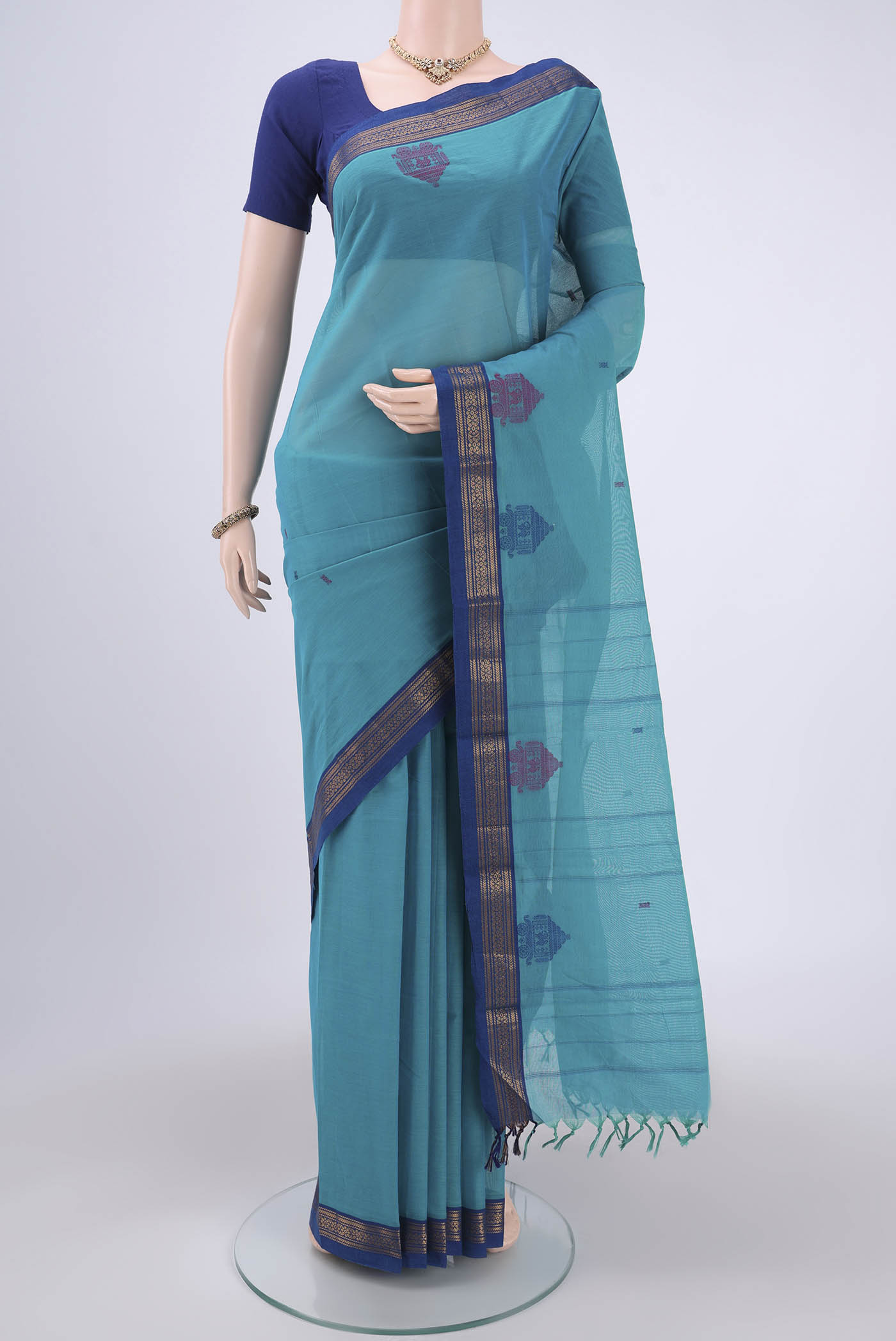 Turquoise Kanchi Cotton Saree with Thread Butta on the body and Thread Border.  displayed on a mannequin