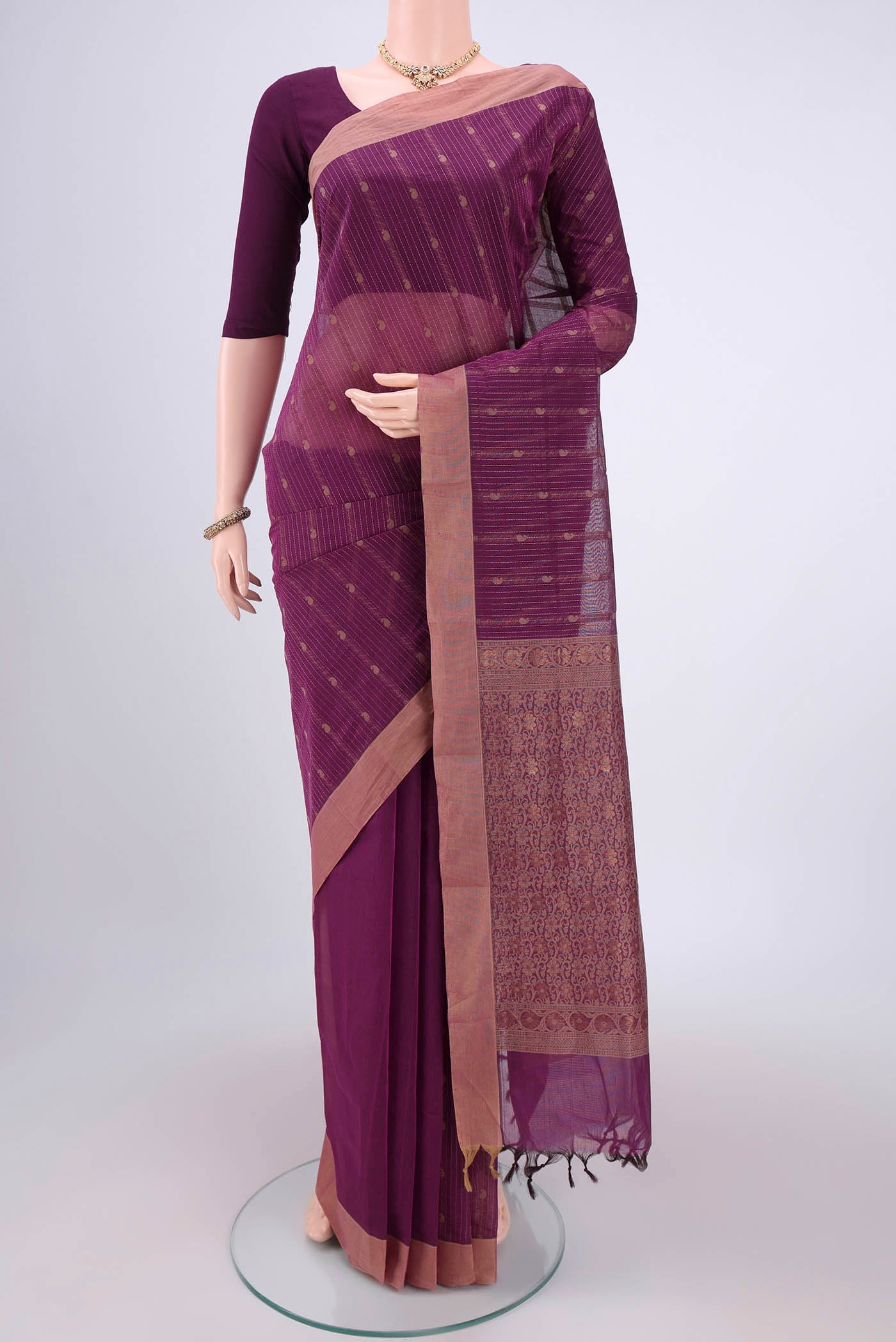 Magenta Kanchi Cotton Saree with Thread Butta on the body and Plain Border.  displayed on a mannequin