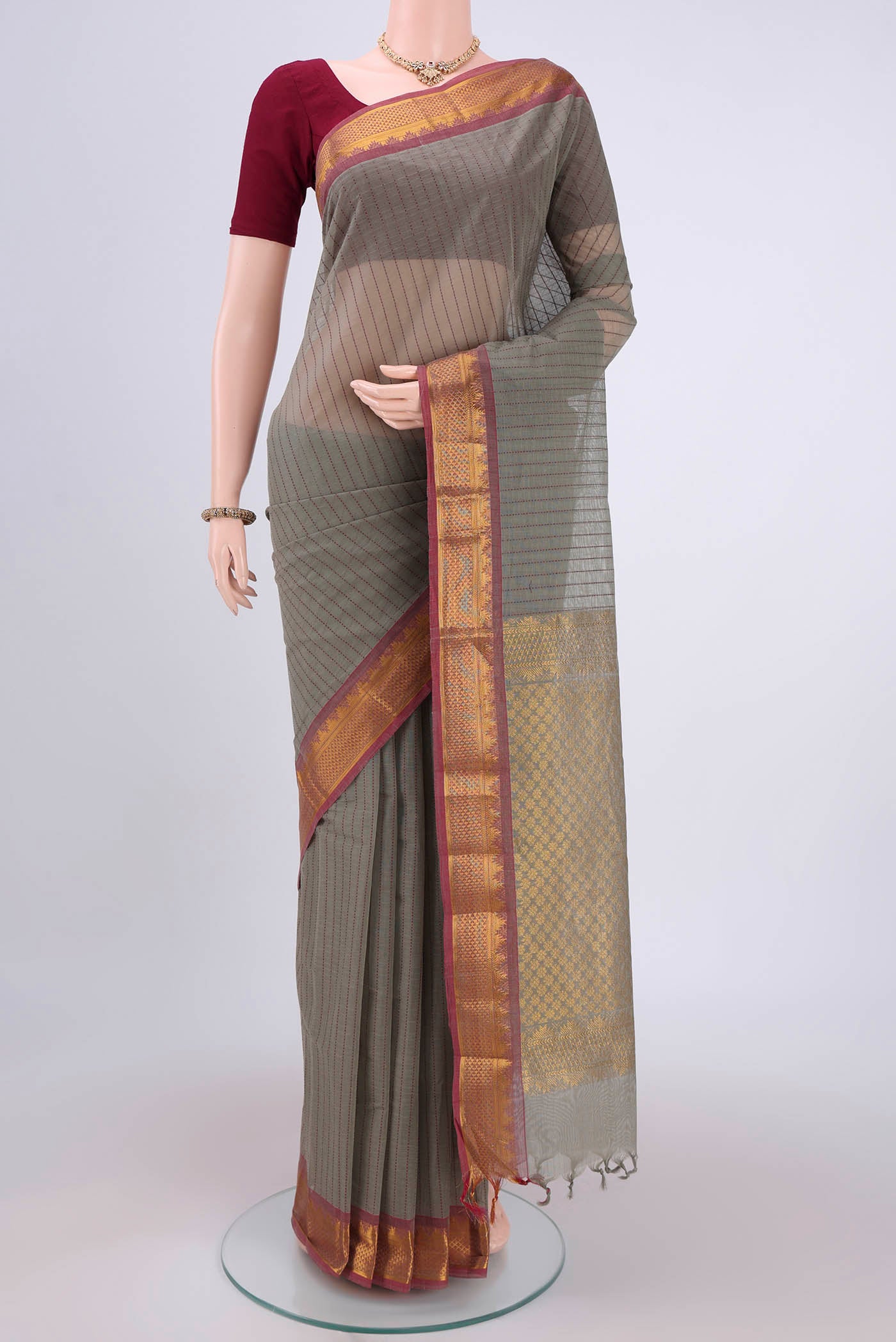 Grey Kanchi Cotton Saree with Stripes on the body and Thread Border.  displayed on a mannequin