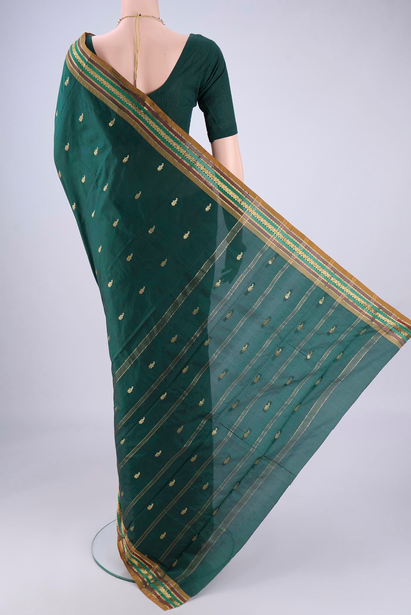 Flat view of Bottle Green Blended Bangalore Silk Saree with Zari Butta on the body and Zari Border. 