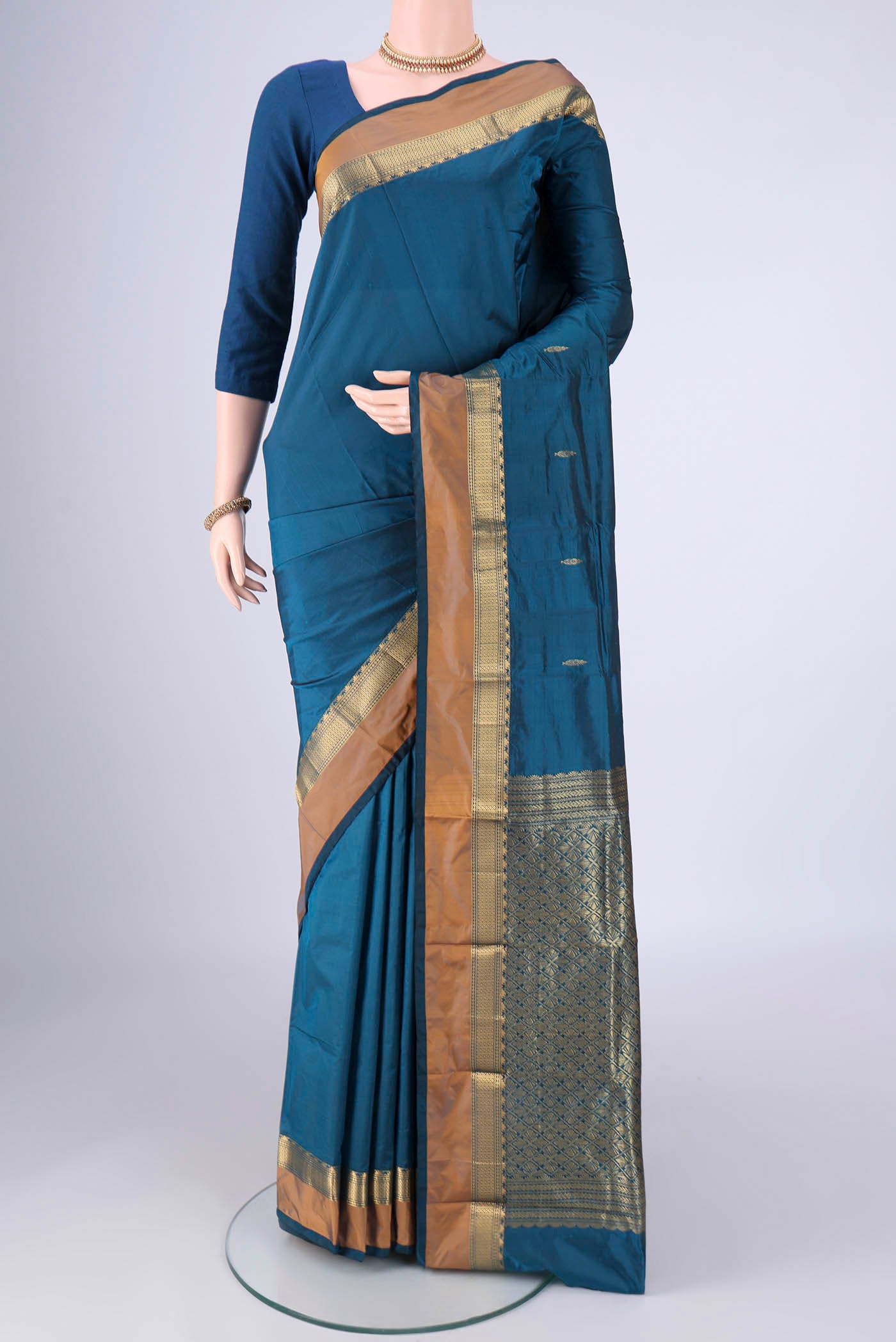 Blue Blended Bangalore Silk Saree with Zari Butta on the body and Zari Border.  displayed on a mannequin