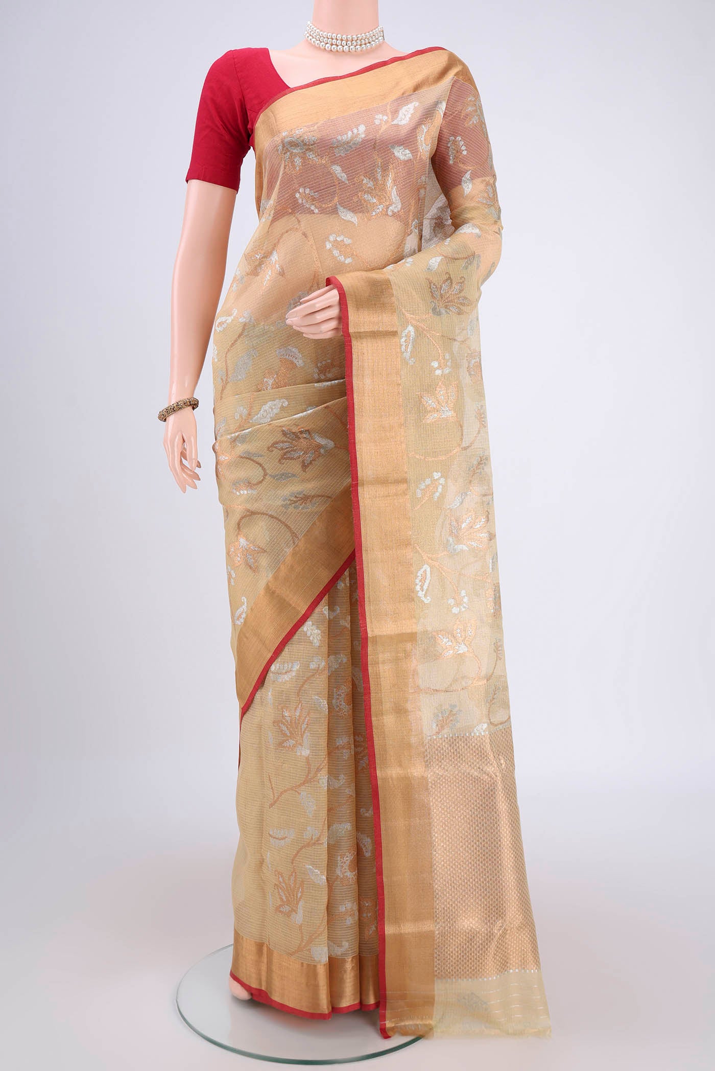 Pure Silk Pure Zari Beige Kota Saree with Zari Butta on the body and Zari Border.  displayed on a mannequin
