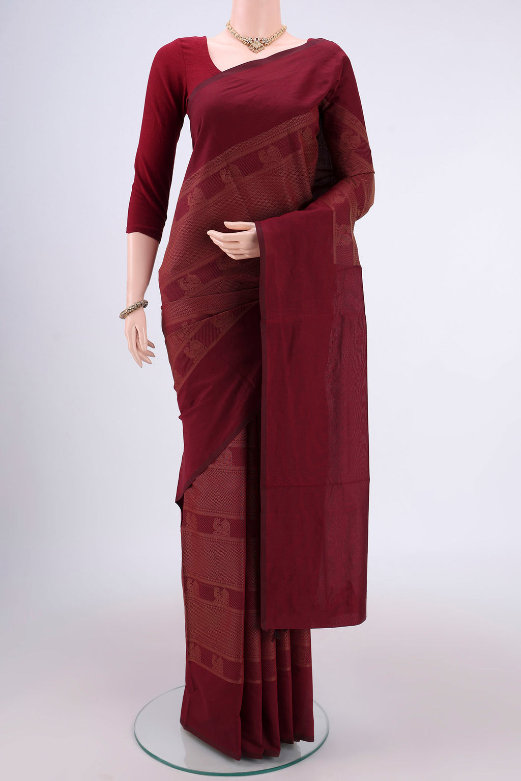 Maroon Blended Poly Cotton Saree with Jacquard design on the body and Plain Border.  displayed on a mannequin