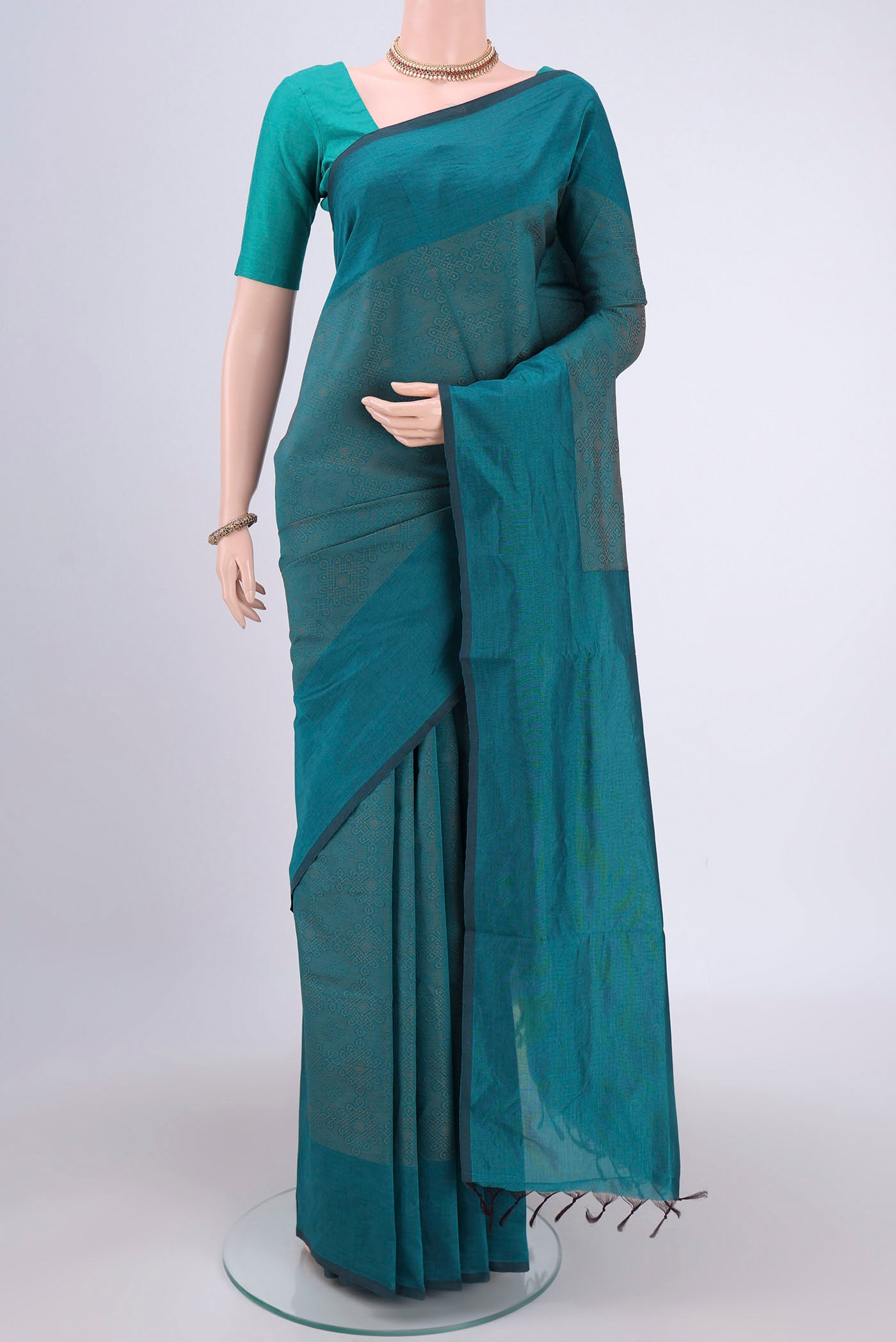 Sea Green Blended Poly Cotton Saree with Jacquard design on the body and Plain Border.  displayed on a mannequin