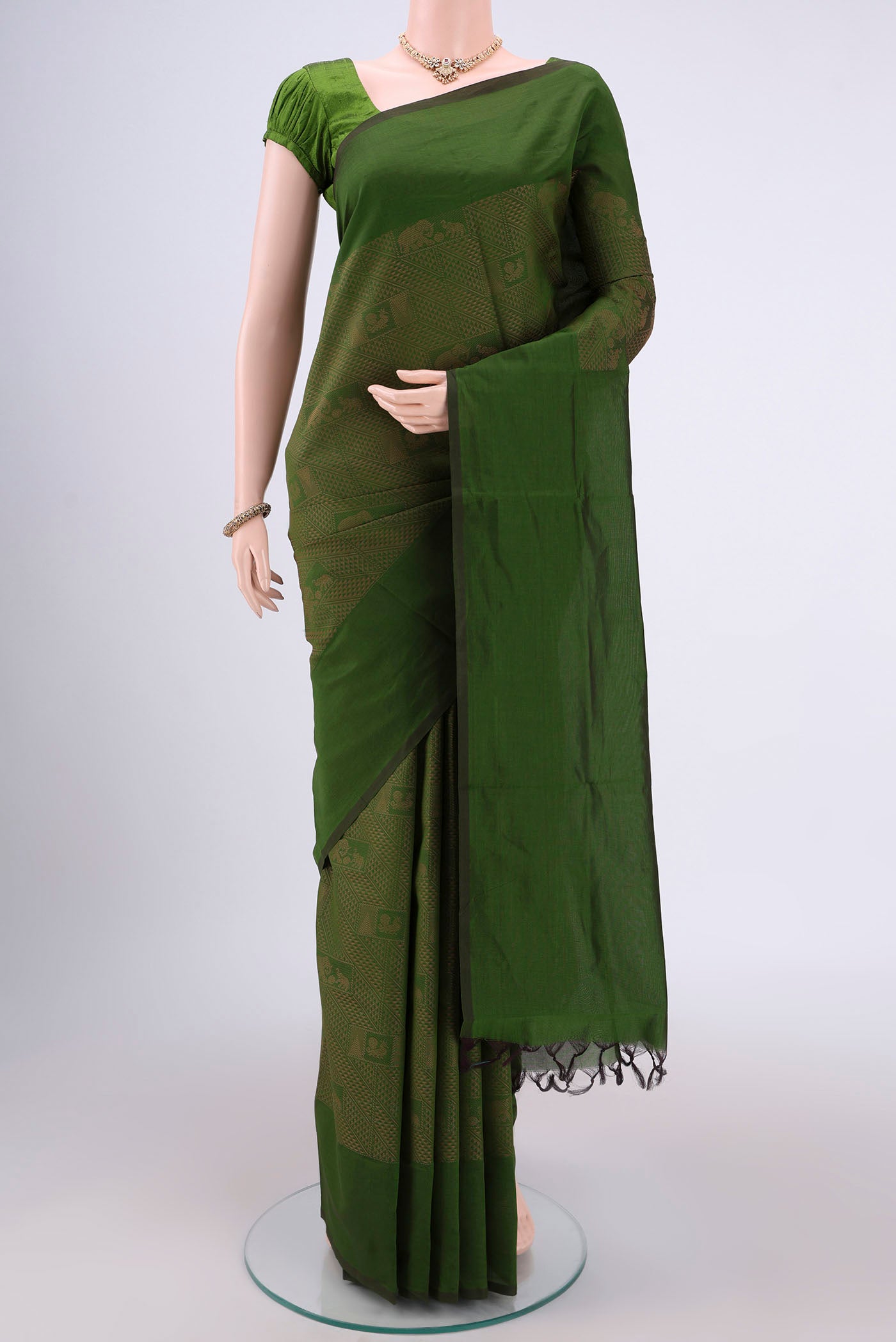 Green Blended Poly Cotton Saree with Jacquard design on the body and Plain Border.  displayed on a mannequin