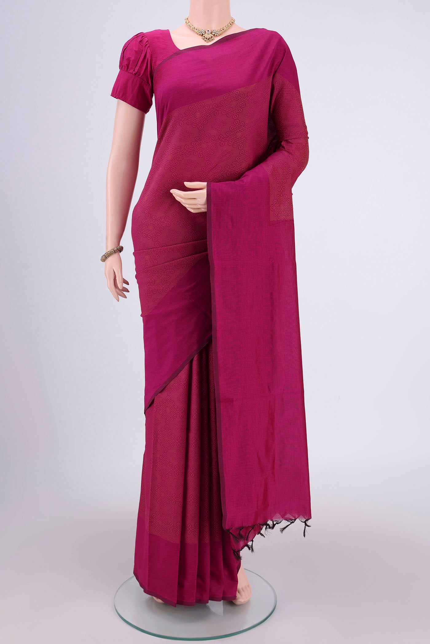 Rani Pink Blended Poly Cotton Saree with Jacquard design on the body and Plain Border.  displayed on a mannequin