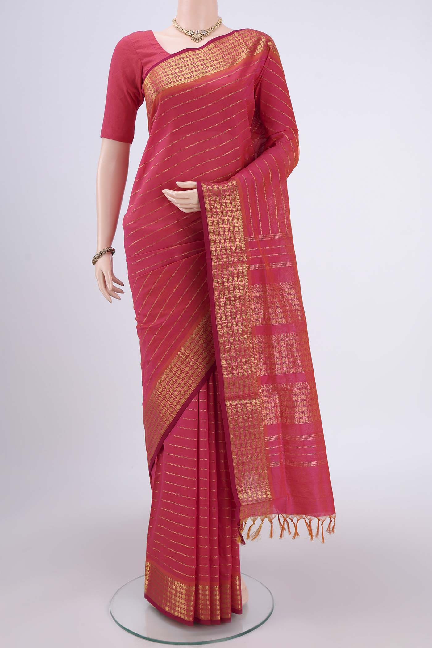 Pink Silk Cotton Saree with Stripes on the body and Plain Border.  displayed on a mannequin