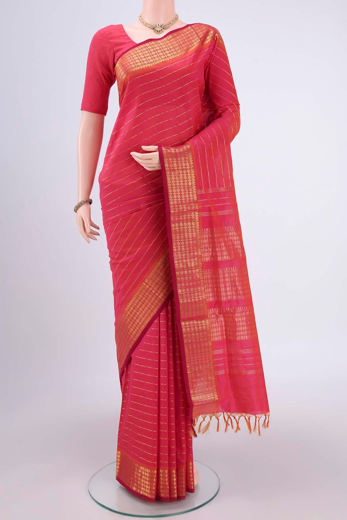 Pink Silk Cotton Saree with Stripes on the body and Plain Border.  displayed on a mannequin