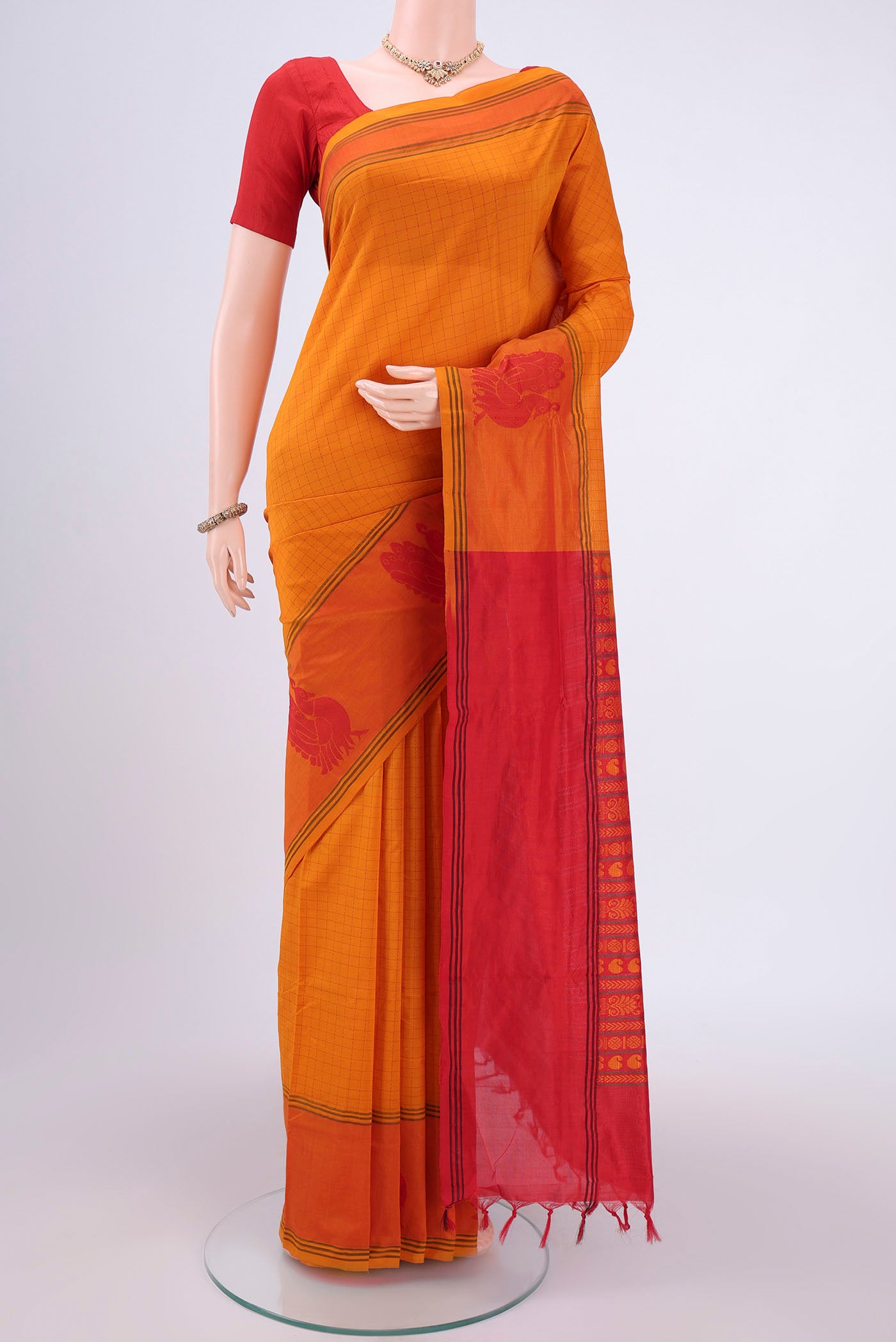 Mustard Blended Poly Cotton Saree with Checked design on the body and Thread Border.  displayed on a mannequin
