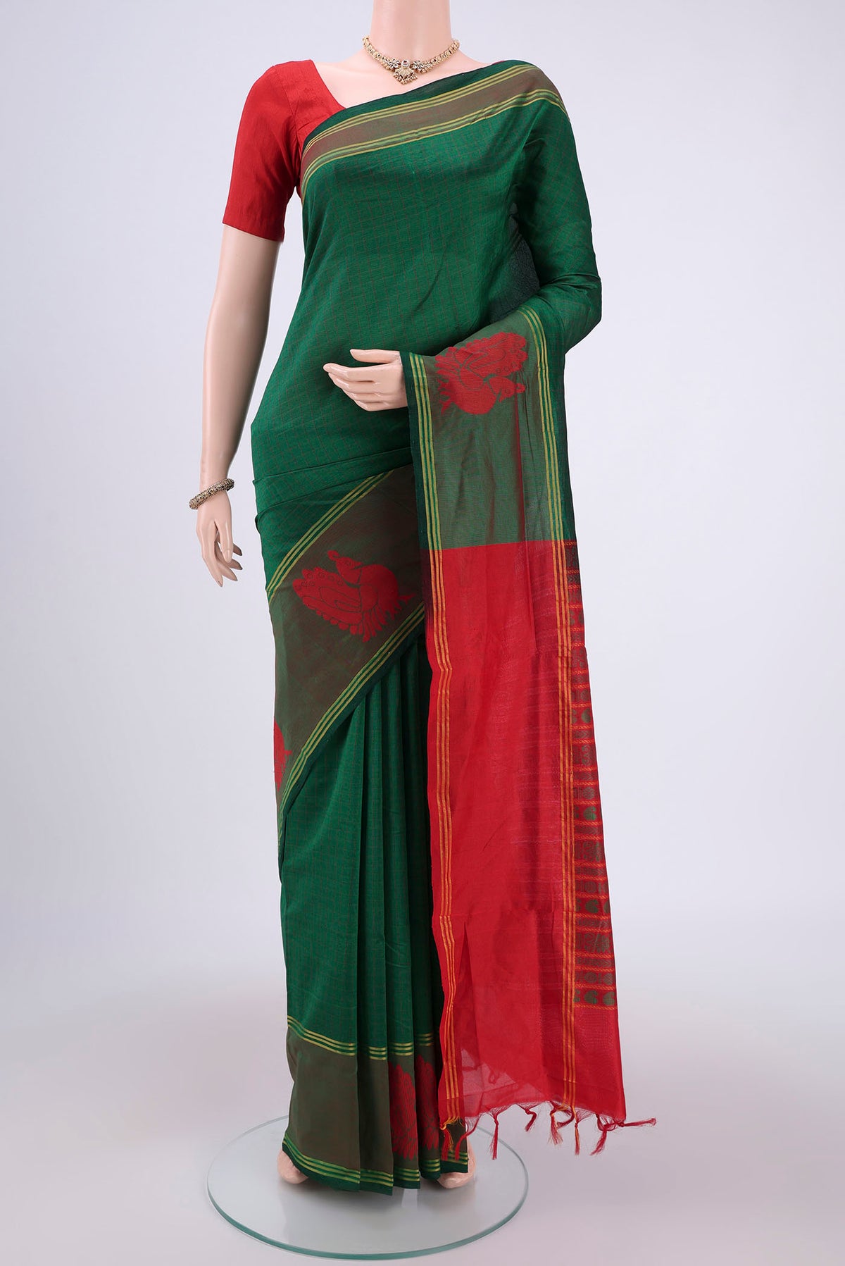 Green Blended Poly Cotton Saree with Checked design on the body and Thread Border.  displayed on a mannequin