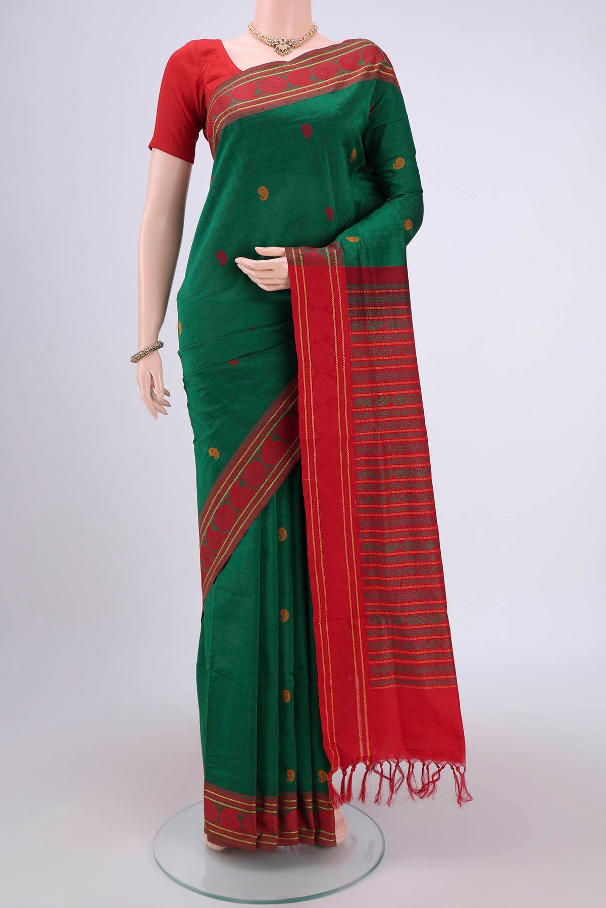 Green Blended Poly Cotton Saree with Thread Butta on the body and Thread Border.  displayed on a mannequin