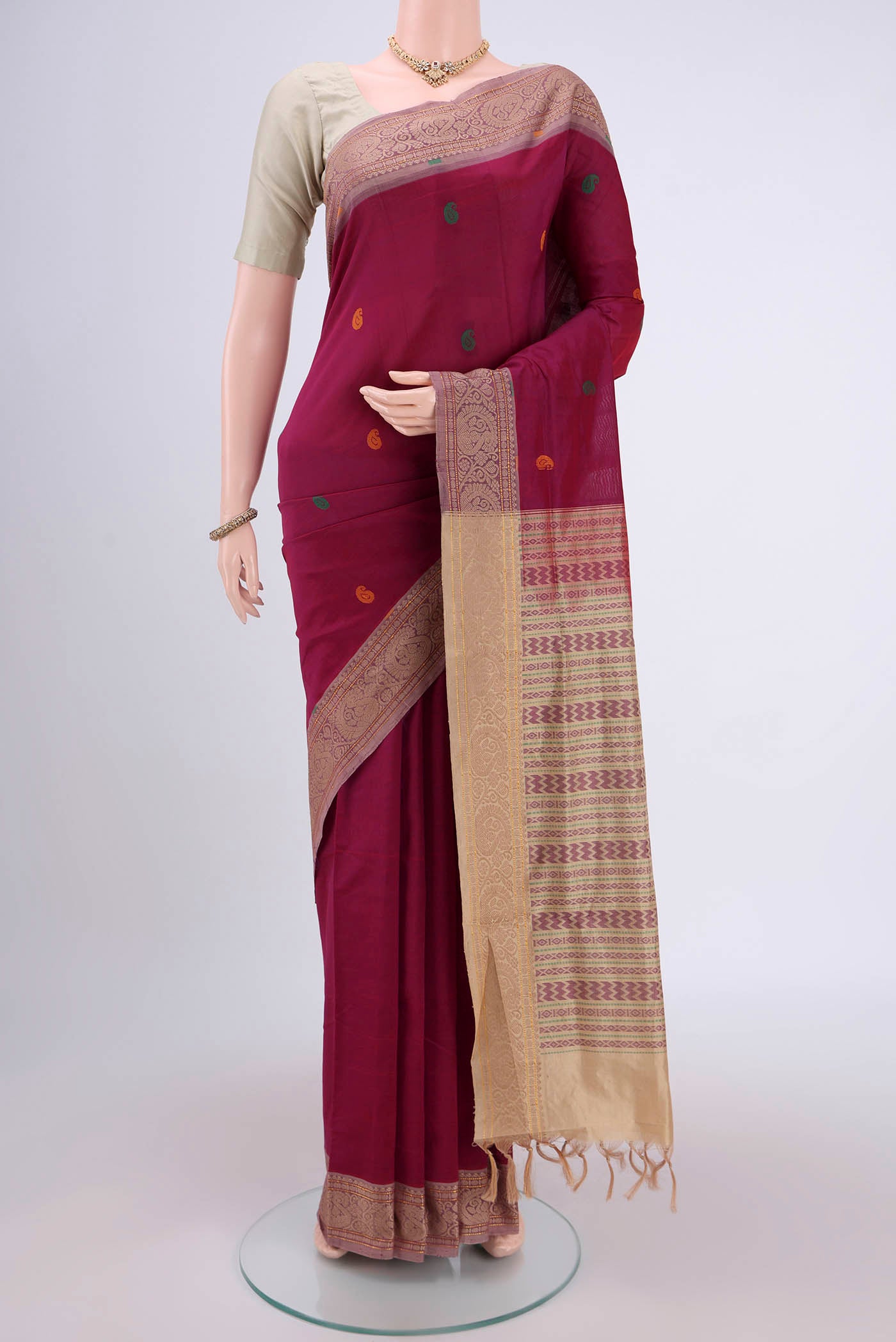 Magenta Blended Poly Cotton Saree with Thread Butta on the body and Thread Border.  displayed on a mannequin