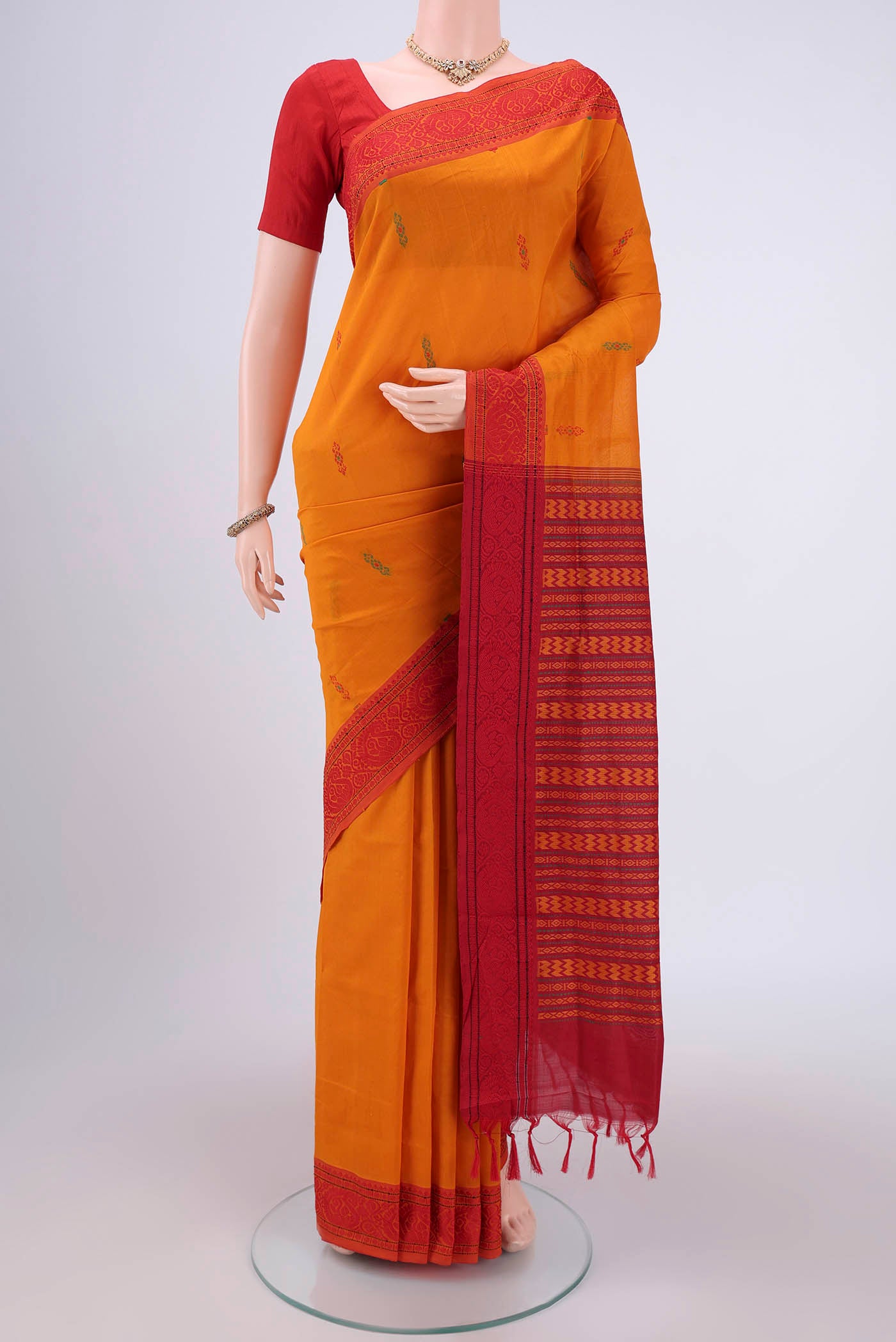Mustard Blended Poly Cotton Saree with Thread Butta on the body and Thread Border.  displayed on a mannequin