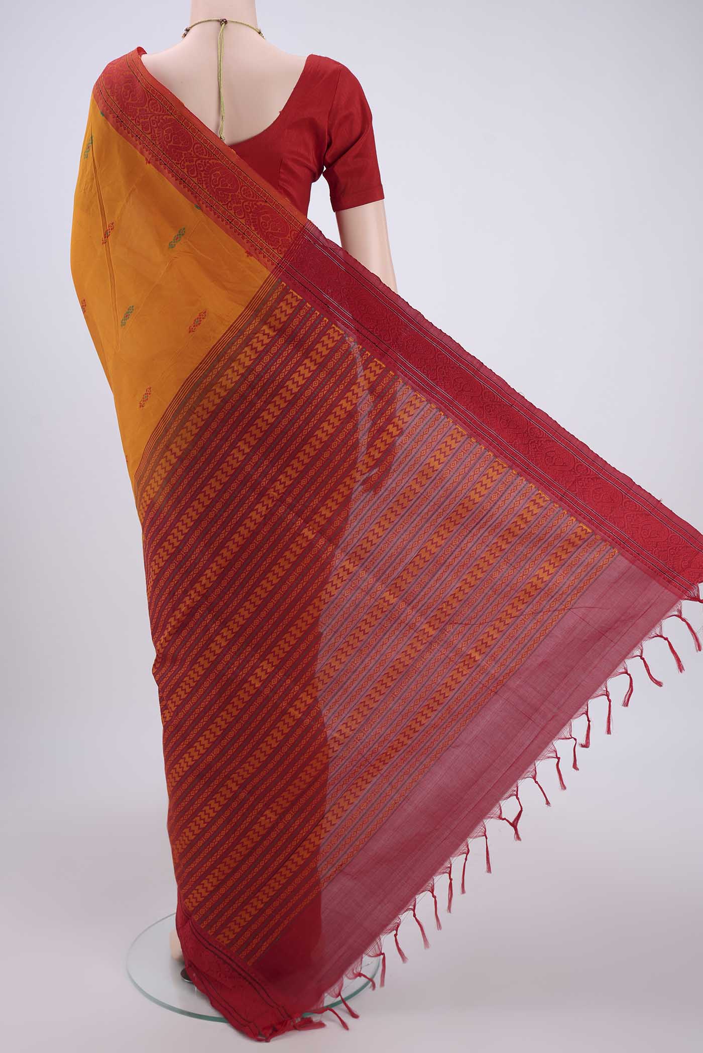 Flat view of Mustard Blended Poly Cotton Saree with Thread Butta on the body and Thread Border. 