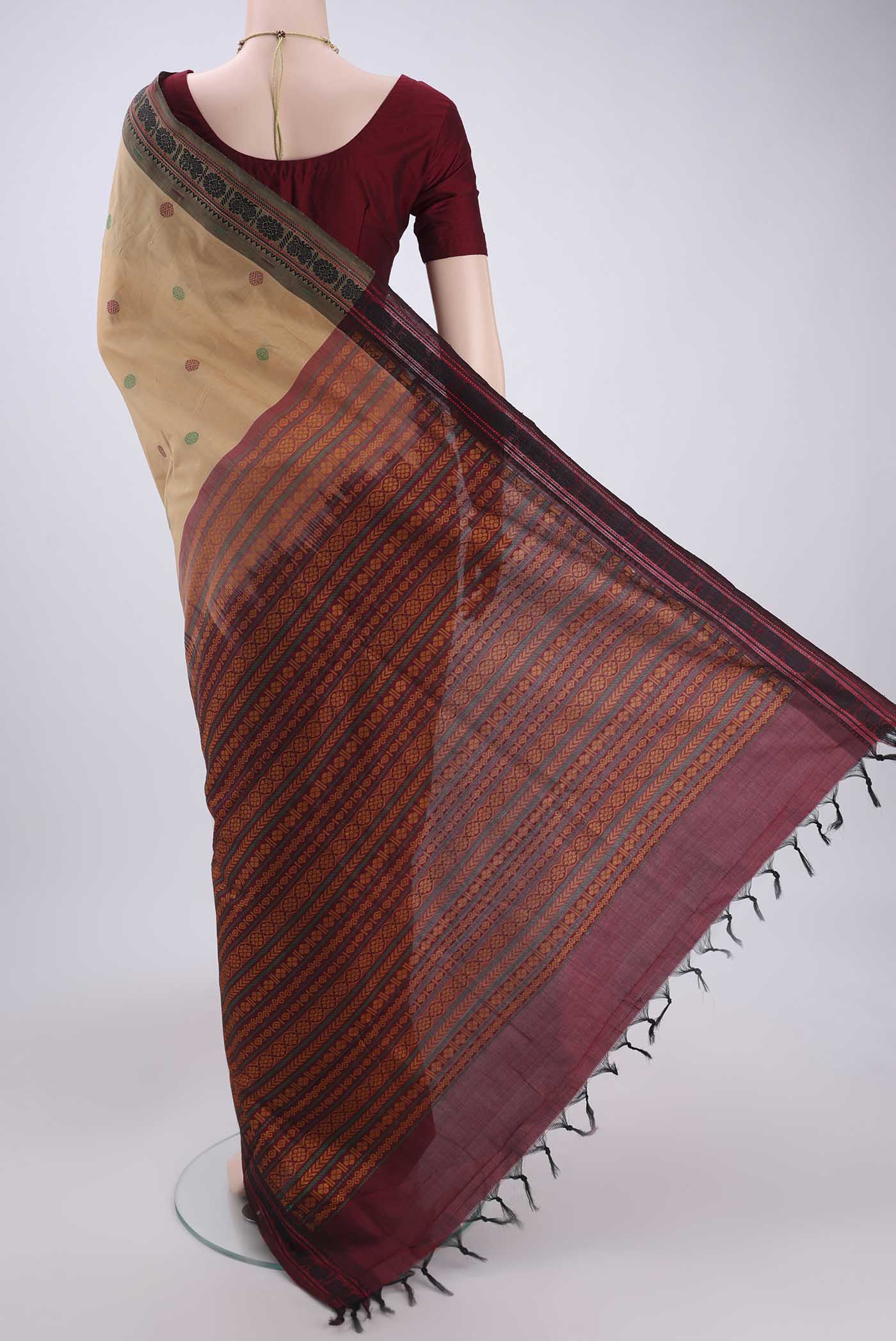 Flat view of Beige Blended Poly Cotton Saree with Thread Butta on the body and Thread Border. 