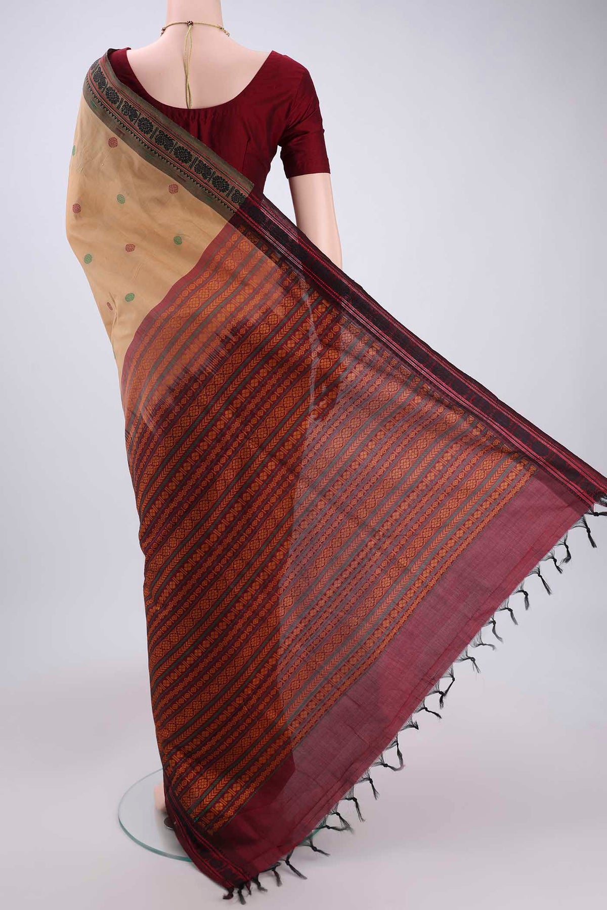 Flat view of Beige Blended Poly Cotton Saree with Thread Butta on the body and Thread Border. 