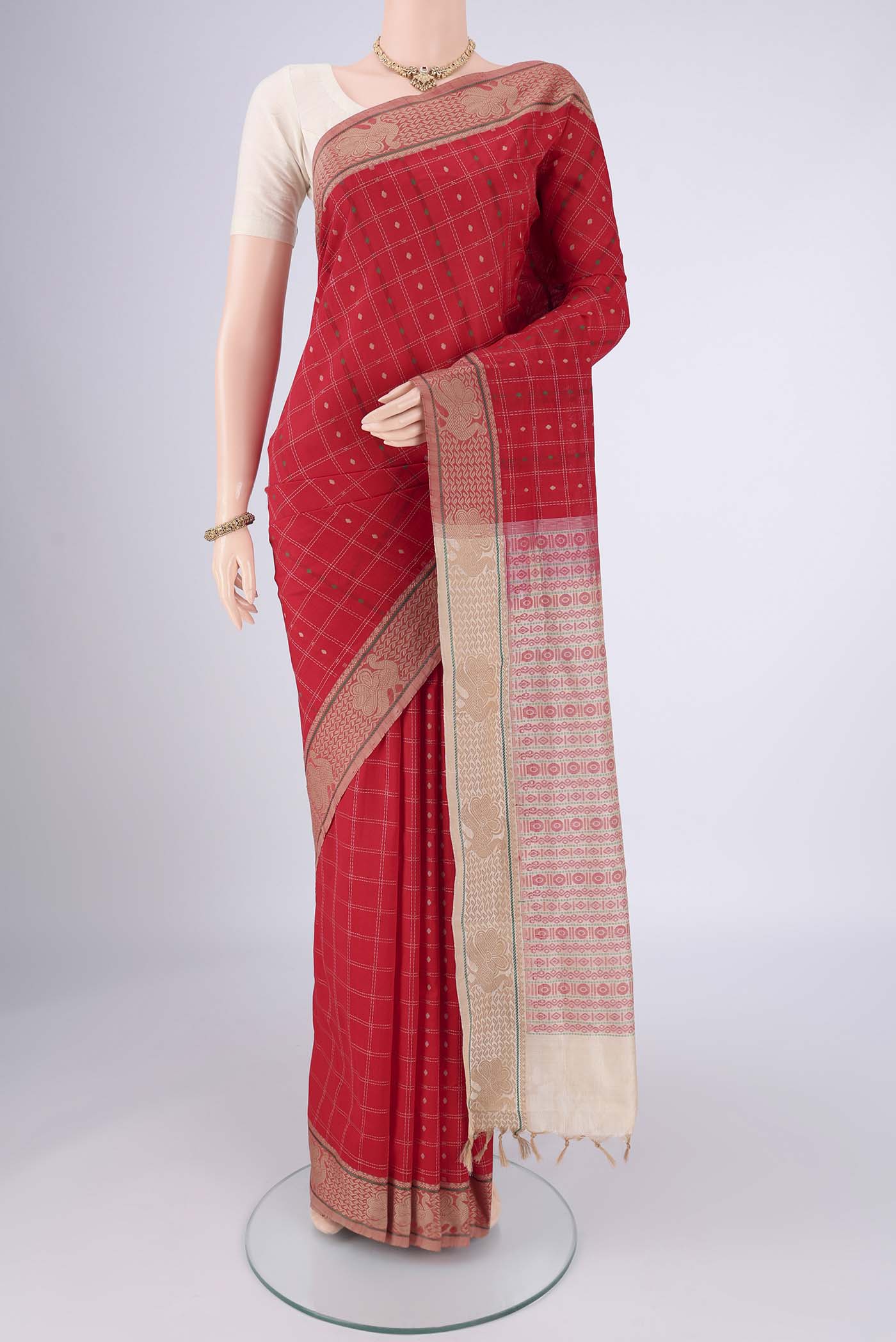 Red Blended Poly Cotton Saree with Checked design on the body and Thread Border.  displayed on a mannequin