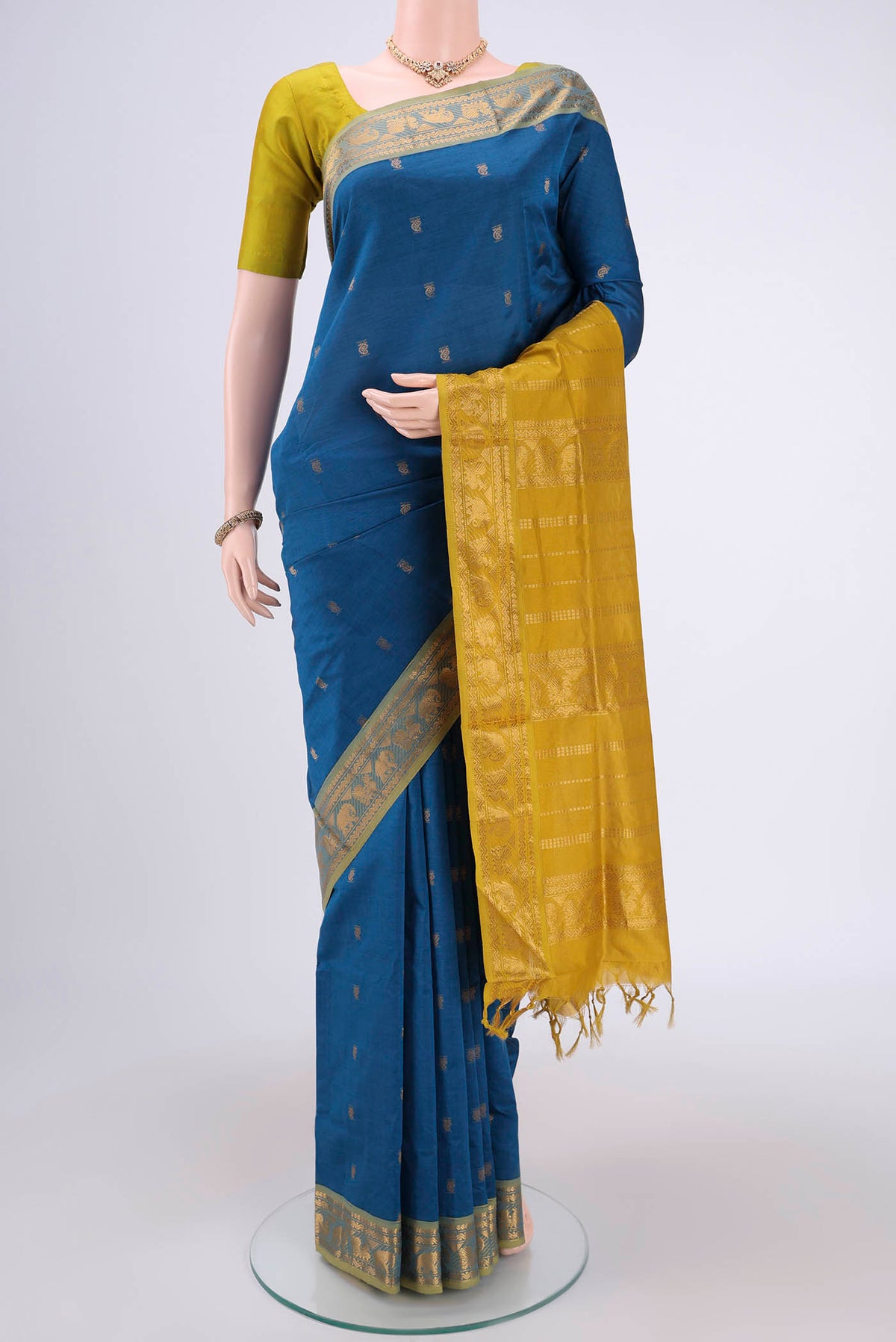 Blue Blended Poly Cotton Saree with Zari Butta on the body and Zari Border.  displayed on a mannequin
