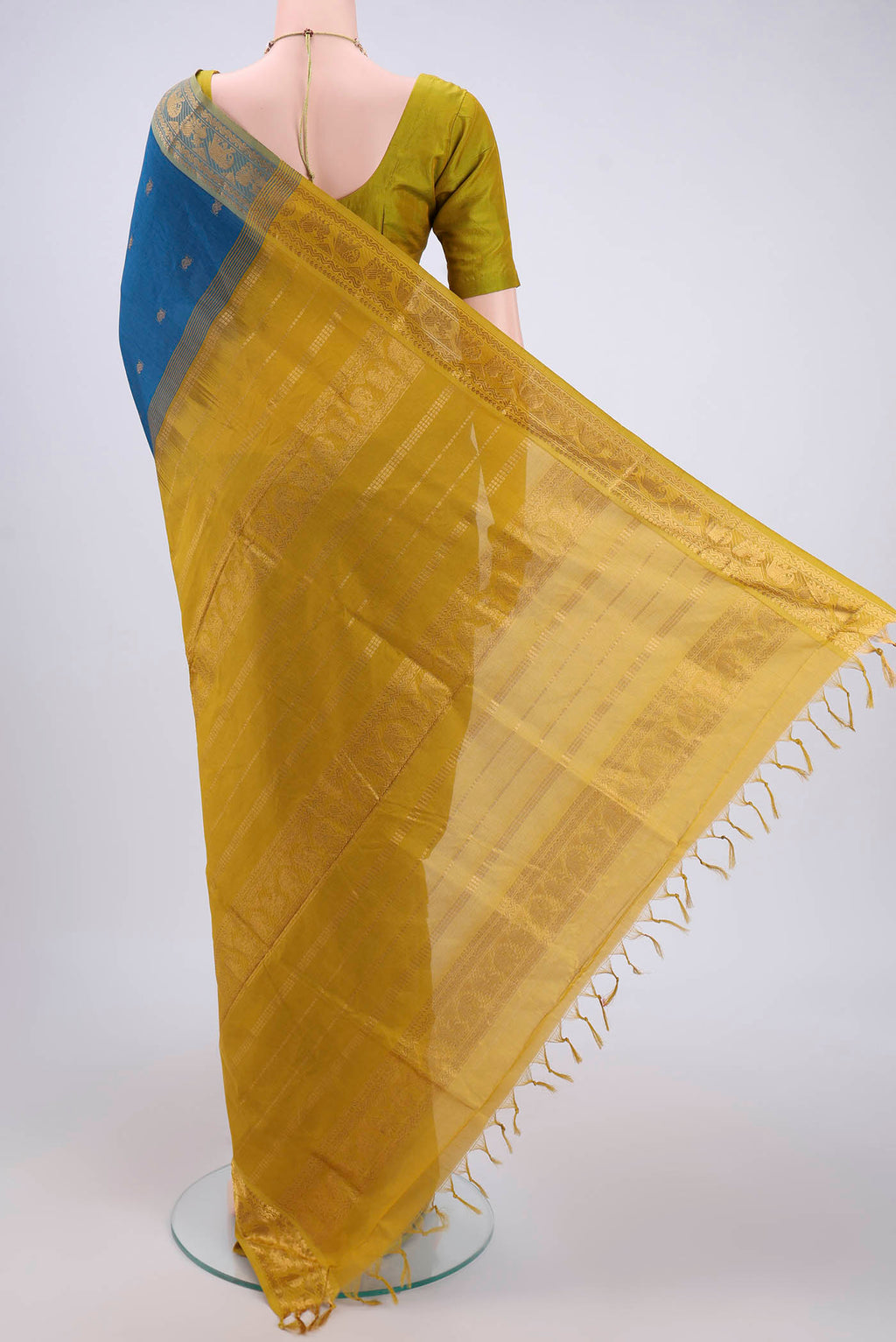 Flat view of Blue Blended Poly Cotton Saree with Zari Butta on the body and Zari Border. 